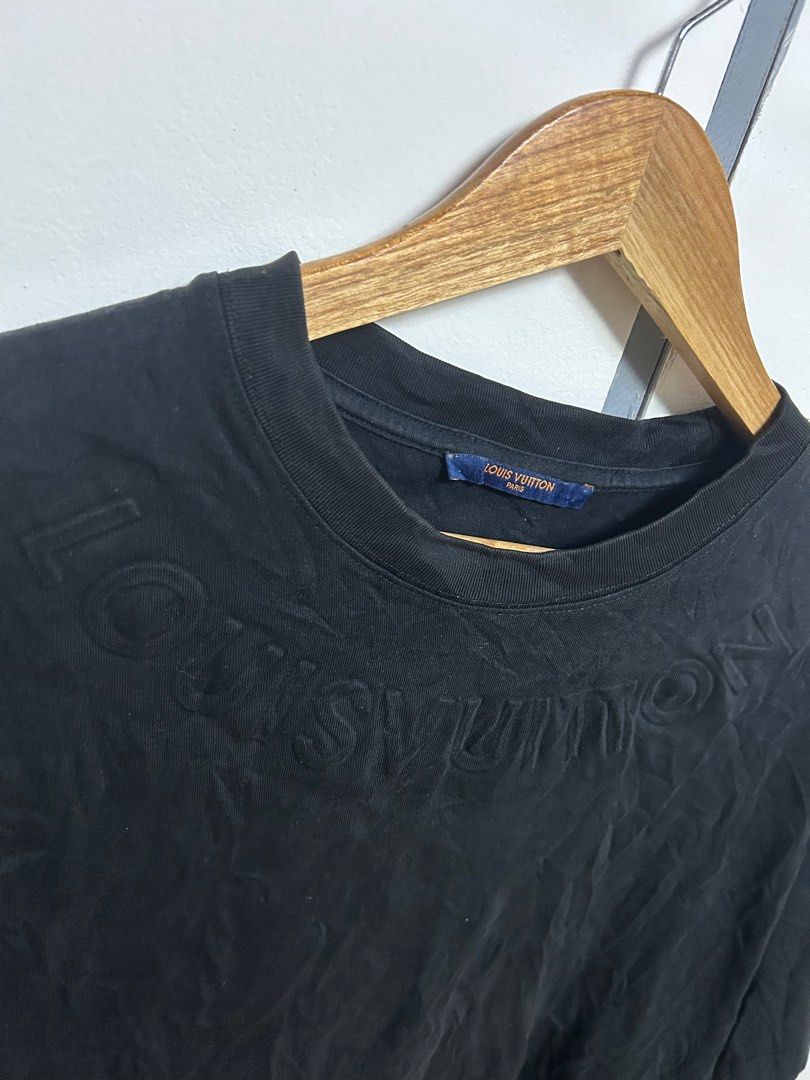 Louis Vuitton Black T-shirt (Category: Luxury Apparel) located in Jordan. Submitted by pareng_j0mar (Listing ID 1419330811, Image 2). Description: - Authentic Louis Vuitton t-shirt - Color: Black - Size: S - Made in Italy - Features embossed Louis Vuitton logo - Crew neck and short sleeves - Includes care instructions and size chart 21 by 28.