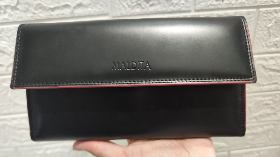 Maldita Black and Red Wallet (Category: Wallets & Card holders) located in Cavite. Submitted by nesstuffandeverything (Listing ID 1419195737, Image 2). Description: - Black Maldita wallet - Red interior - Multiple card slots - Clear ID window - Zippered compartment - Snap closure.