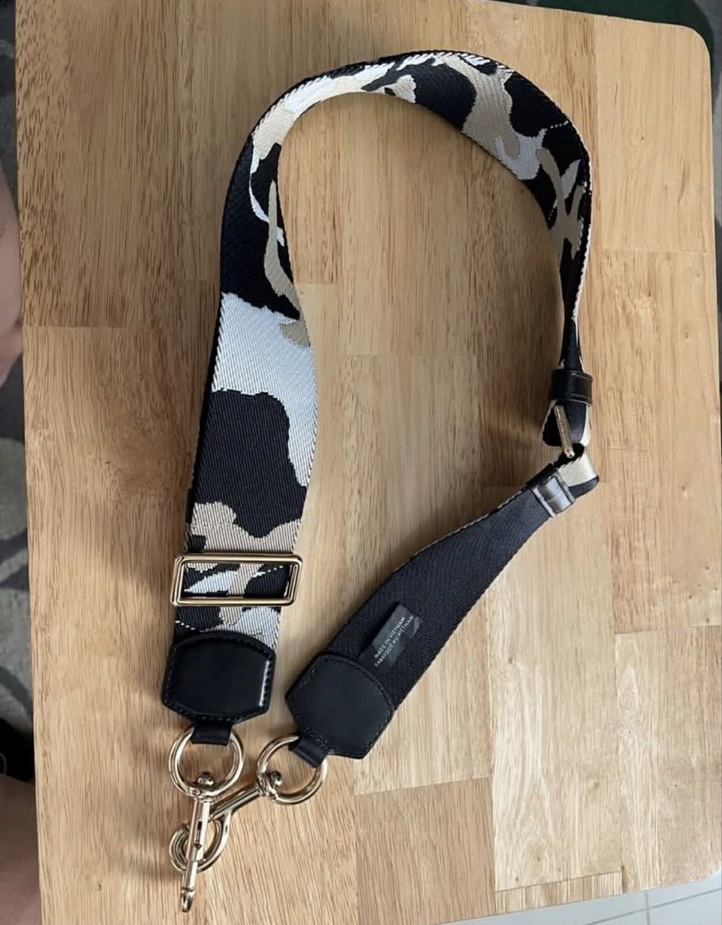 Marc Jacobs Camo Bag Strap (Category: Luxury Bags & Wallets) located in Pasig City. Submitted by cherfer13 (Listing ID 1419215848, Image 2). Description: - Marc Jacobs bag strap - Stylish black, gray, and beige camo pattern - Features gold-tone hardware - Includes leather accents - Approximately 5 cm wide - Metal clasp for easy attachment - Made in Vietnam.