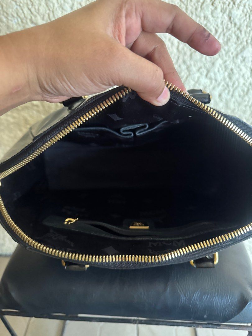 MCM Bowler Bag-original preloved (Category: Luxury Bags & Wallets) located in Manila. Submitted by nylan1227 (Listing ID 1419322353, Image 3). Description: - Authentic MCM bowler bag - Glossy black exterior - Gold-tone hardware - Interior zippered pocket and slip pocket - Double top handles - Detachable shoulder strap (missing) - Includes MCM dust bag.