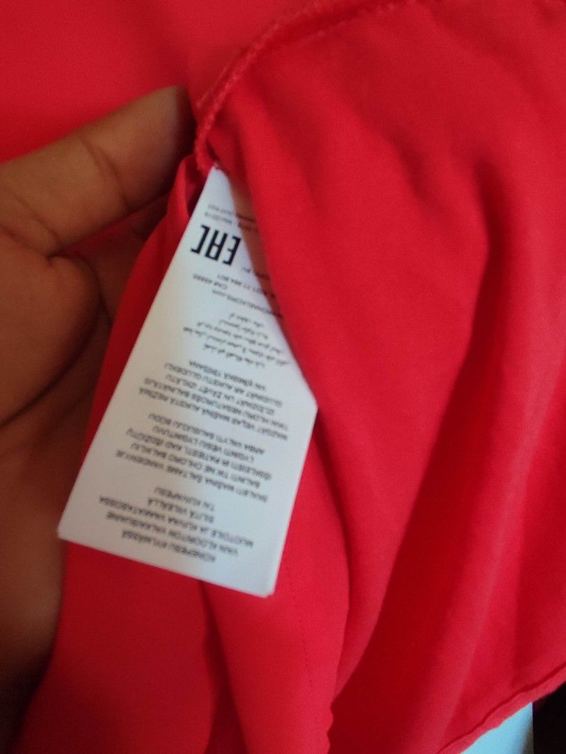 Michael Kors Sleeveless V-Neck Top (Category: Sleeveless) located in Mangaldan. Submitted by michelle_2004 (Listing ID 1419289155, Image 3). Description: Bright red sleeveless top from Michael Kors. Features a V-neck design. The tag indicates the size is L. The top has a layered design at the bottom. The Michael Kors logo is visible on the neckline..