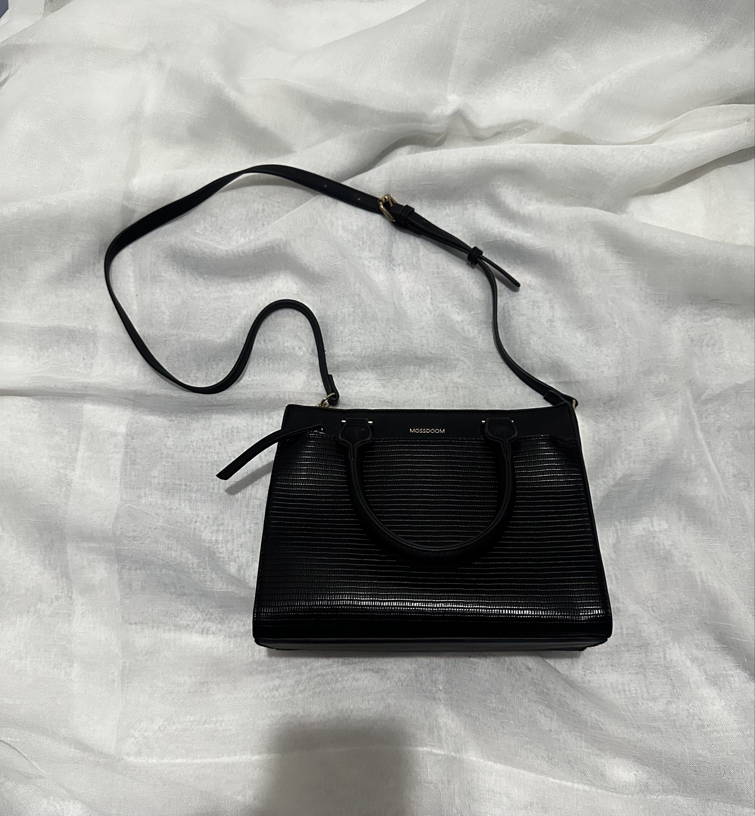 Mossdoom Black Handbag with Shoulder Strap (Category: Shoulder Bags) located in Pasay City. Submitted by j9declutter (Listing ID 1419333274, Image 1). Description: Decluttering! Selling low!!! Pick-up via grab/move it/joyride/angkas/lalamove only. NO COD! If in doubt, wag bumili 😁 You can pay thru BPi & Gcash only. Happy shopping! ❤️❤️❤️ - Black Mossdoom handbag - Top handle and detachable shoulder strap - Textured exterior - Zippered main compa