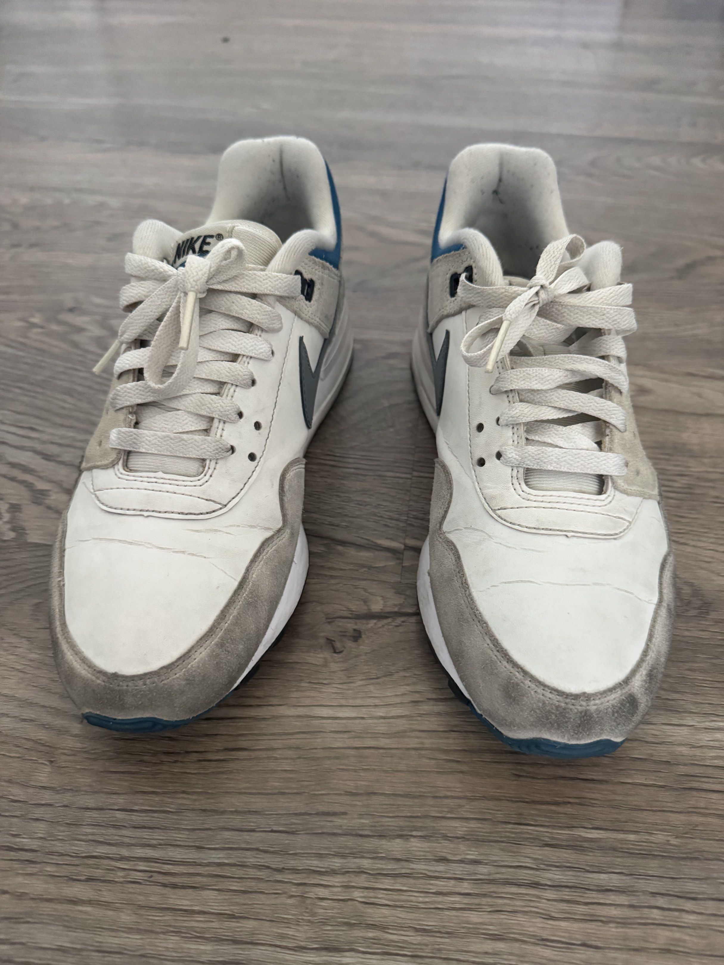 Nike Air Pegasus 89 Sneakers (Category: Sneakers) located in Pasig City. Submitted by mp39393 (Listing ID 1419248010, Image 3). Description: - Nike Air Pegasus 89 sneakers - Color: White, Grey, Blue - Size: US 8.5, UK 7.5, EUR 42, BR 40 - Features Nike swoosh logo - Shows visible wear on soles and uppers - Includes laces and Nike Air logo on heel - No sole separation - RFS - need bigger size shoes.