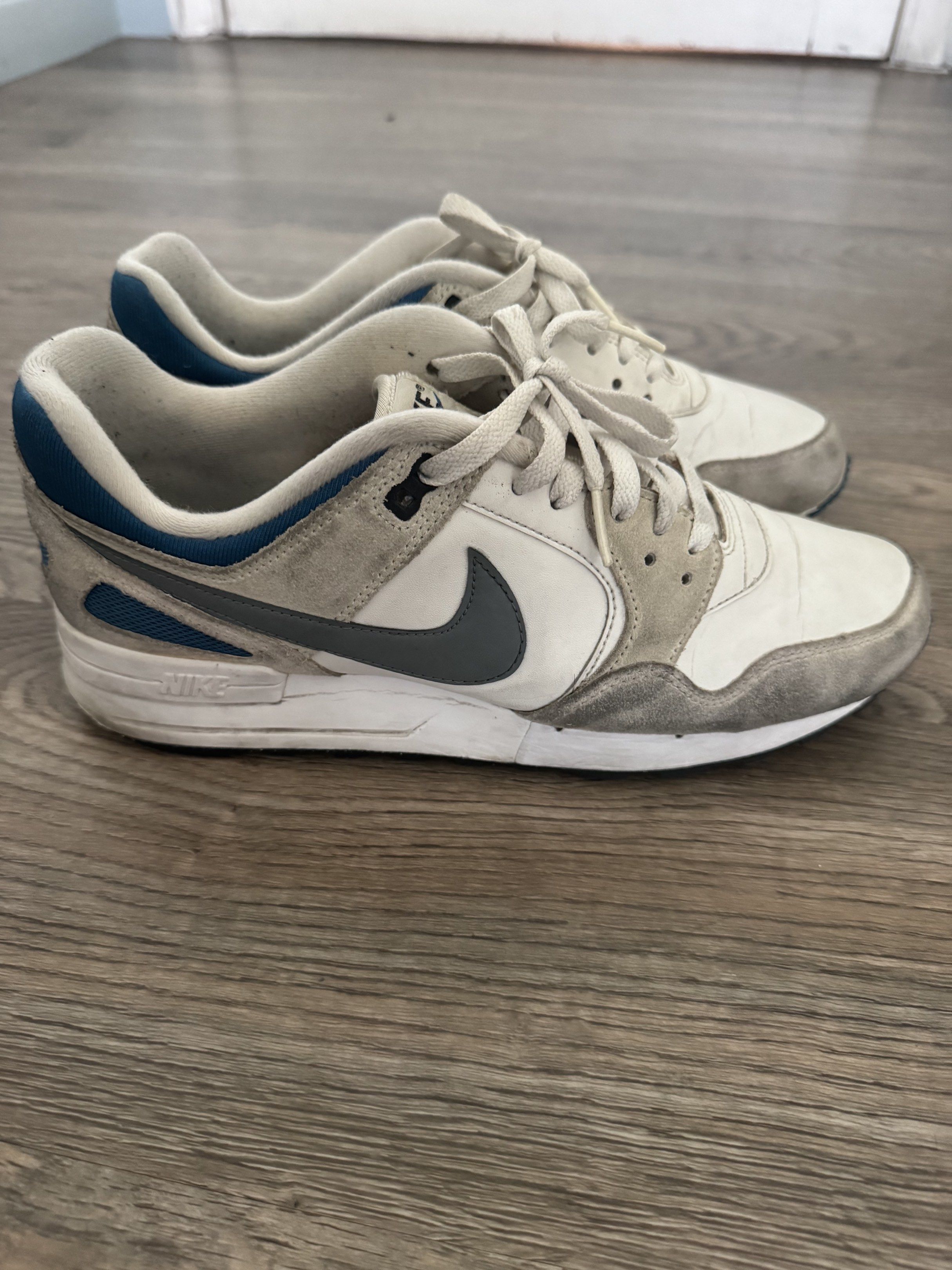 Nike Air Pegasus 89 Sneakers (Category: Sneakers) located in Pasig City. Submitted by mp39393 (Listing ID 1419248010, Image 2). Description: - Nike Air Pegasus 89 sneakers - Color: White, Grey, Blue - Size: US 8.5, UK 7.5, EUR 42, BR 40 - Features Nike swoosh logo - Shows visible wear on soles and uppers - Includes laces and Nike Air logo on heel - No sole separation - RFS - need bigger size shoes.
