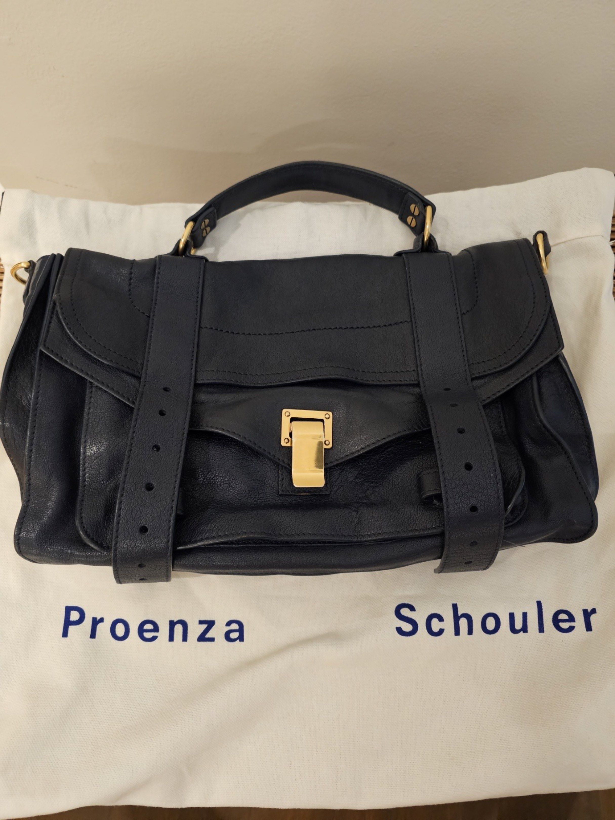 Proenza Schouler PS1 Satchel Bag (Category: Luxury Bags & Wallets) located in Paranaque City. Submitted by helloasher (Listing ID 1419253910, Image 3). Description: - Proenza Schouler PS1 satchel bag - Color: Navy blue - Features: - Top handle - Adjustable shoulder strap - Gold-tone clasp - Includes dust bag - Material: Leather.