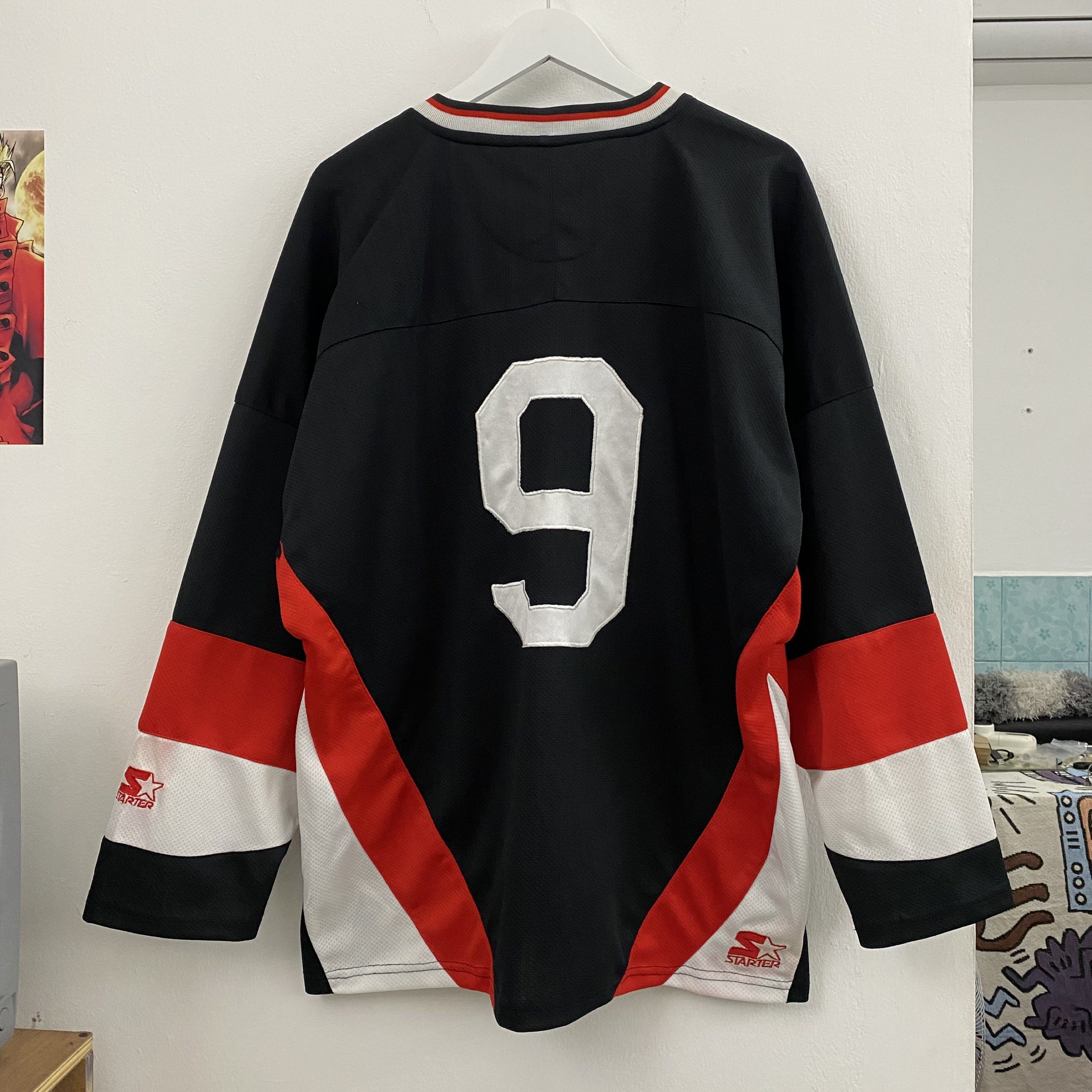 Starter NWO Hockey Jersey (Category: Activewear) located in Cavite. Submitted by mana__ (Listing ID 1419378654, Image 2). Description: - Vintage Starter hockey jersey - Features NWO (New World Order) logo - Number 9 on the back - Color: Black with red and white accents - Size: Large - V-neck collar with Starter branding - Issue : bleed - Dimension Large Width - 28.5 Length - 30 .