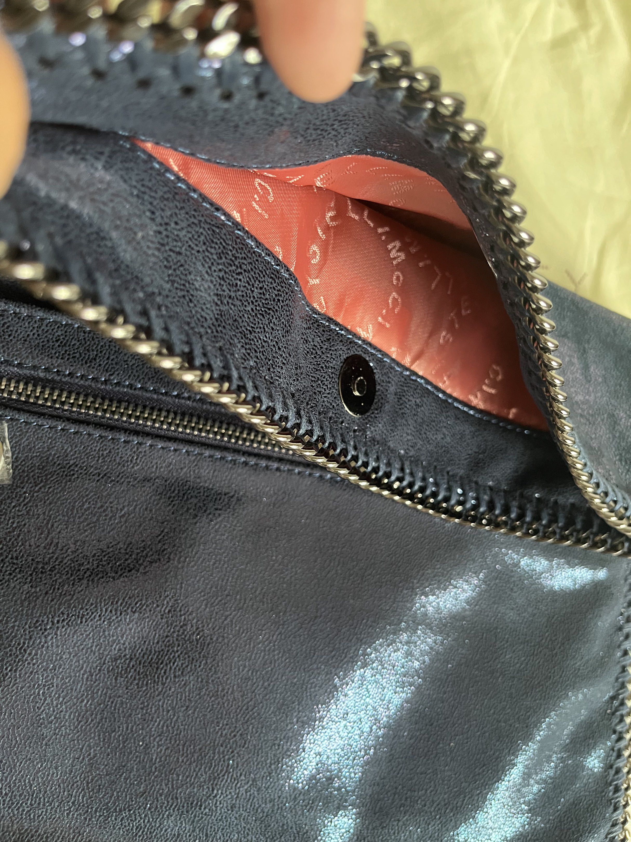 Stella McCartney Falabella Clutch (Category: Luxury Bags & Wallets) located in Manila. Submitted by mentone (Listing ID 1419258219, Image 3). Description: - Navy blue Stella McCartney Falabella clutch - Chain trim detail - Magnetic snap closure - Interior zippered pocket - Light pink interior lining - Includes dust bag - Metallic sheen.