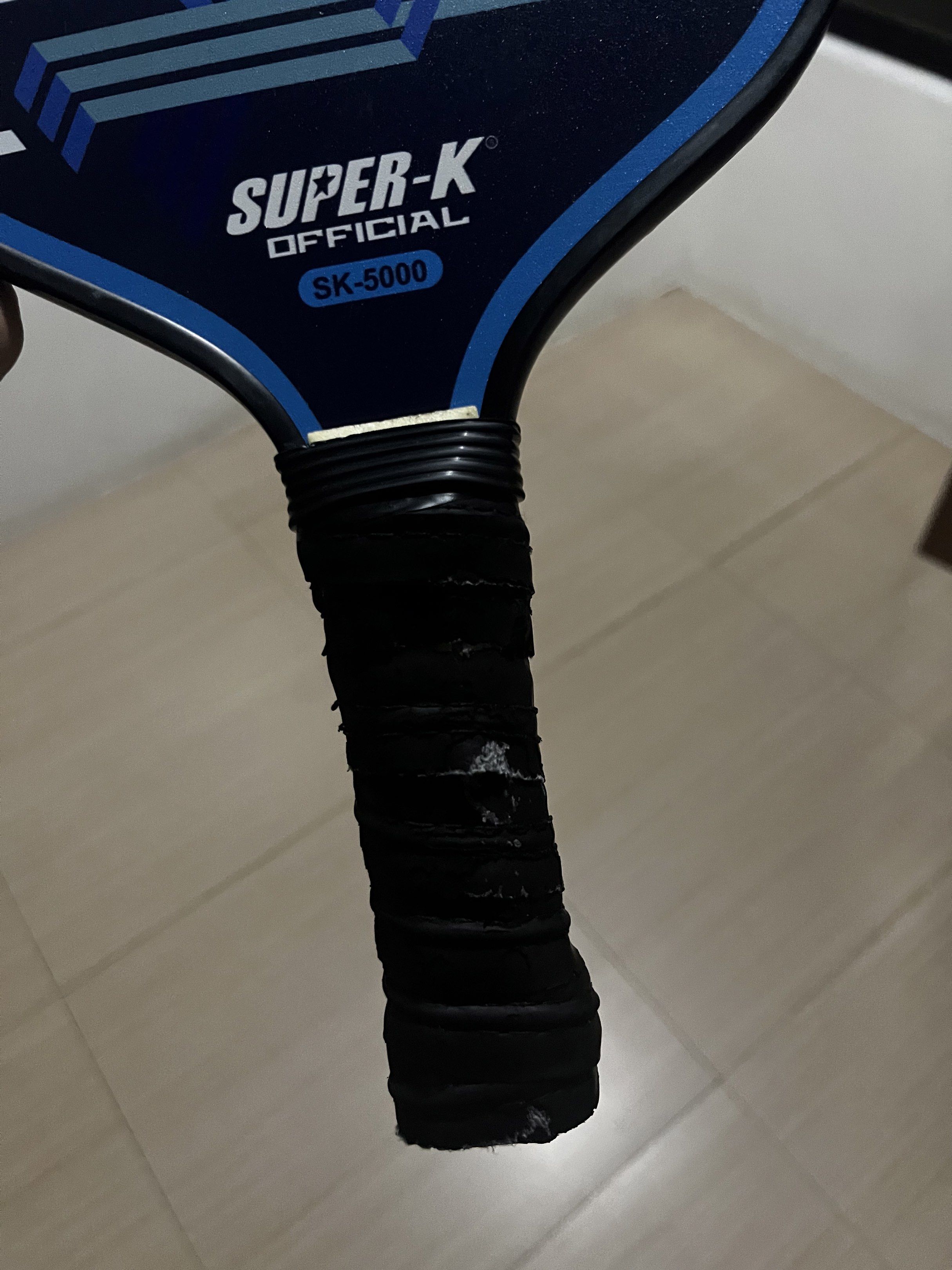 Super-K Official SK-5000 Pickleball Paddle (Category: Racket and Ball Sports) located in Paranaque City. Submitted by captainthanos01 (Listing ID 1419302876, Image 2). Description: Super-K Official SK-5000 pickleball paddle features a blue and white geometric design. The grip is black. It is suitable for pickleball games..