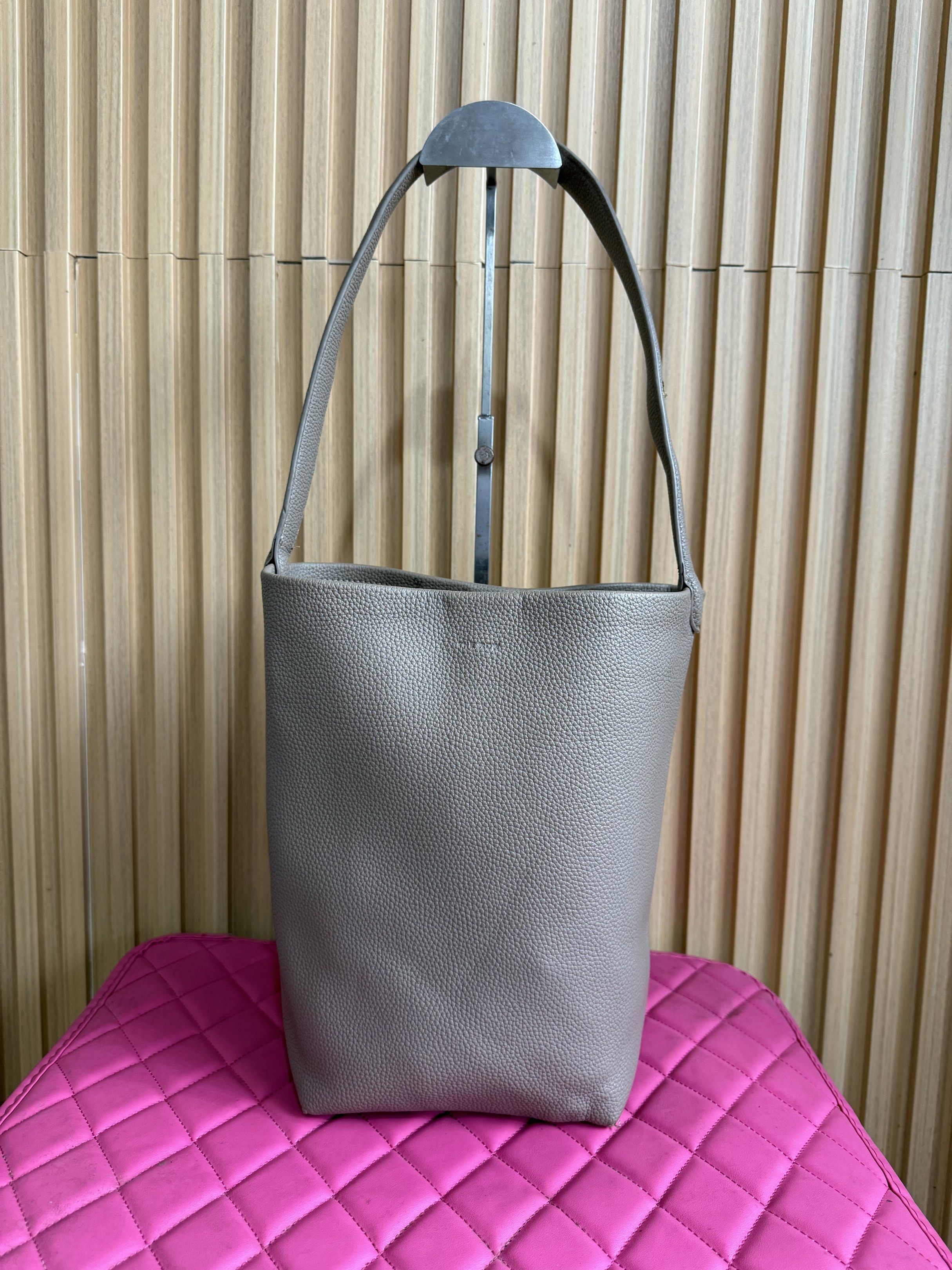 The Row Leather Bucket Bag (Category: Luxury Bags & Wallets) located in Lipa City. Submitted by thyra06 (Listing ID 1419389608, Image 2). Description: - The Row bucket bag - Crafted from textured leather - Single shoulder strap - Spacious interior - Versatile neutral color - Lined interior - Minor imperfection on strap.