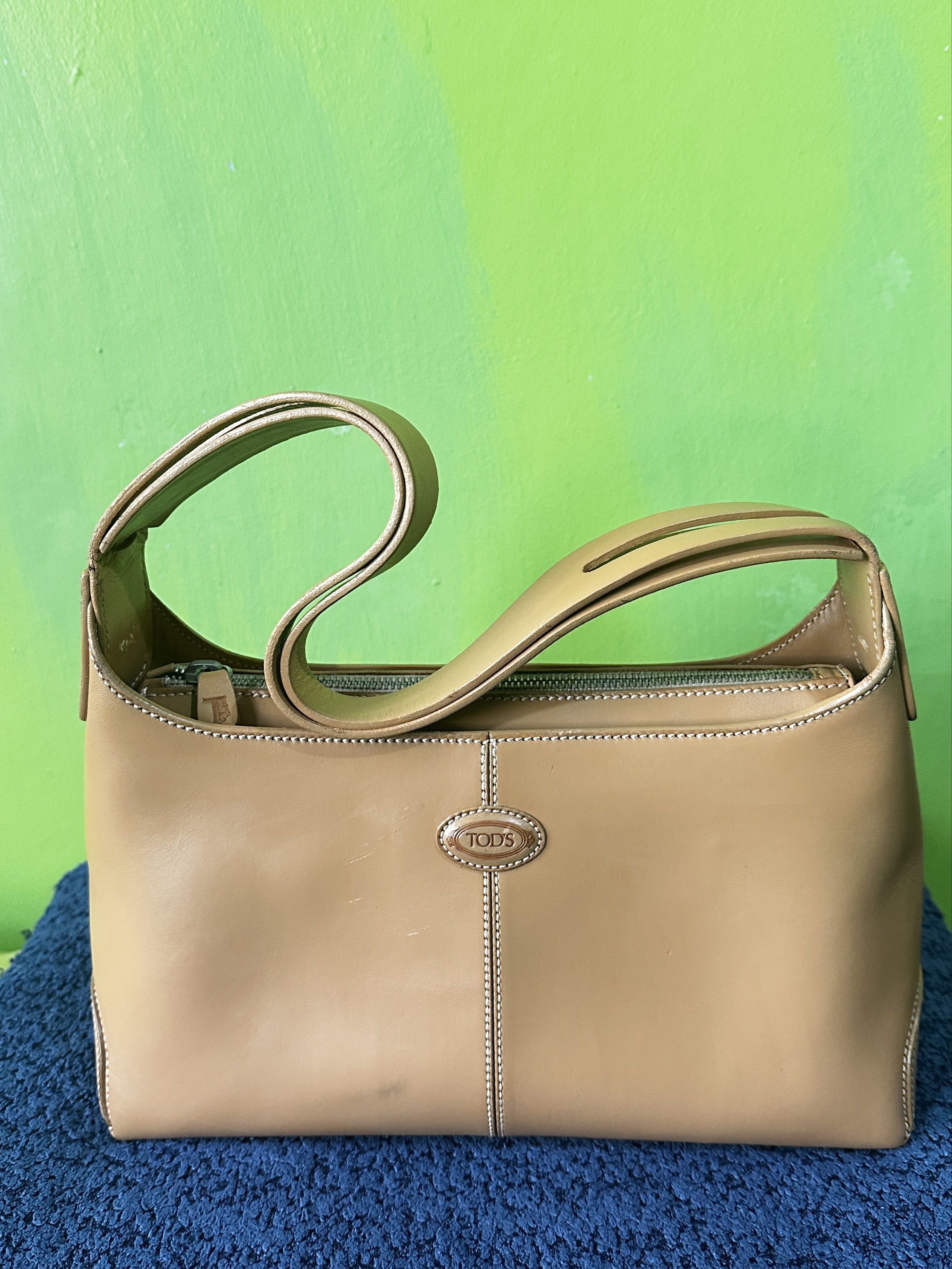 Tod's Camel Leather Classic Hobo Shoulder Bag (Category: Luxury Bags & Wallets) located in Angeles City. Submitted by n_cln (Listing ID 1419193702, Image 1). Description: - guaranteed Authentic Tod's classic shoulder bag in Camel - genuine leather made in Italy - working top zipper closure w/ shoulder strap - w/ stitched detailing and metal feet - bought in a lux vintage shop in Tokyo - was repainted (per shop) & has minimal scratches which are b