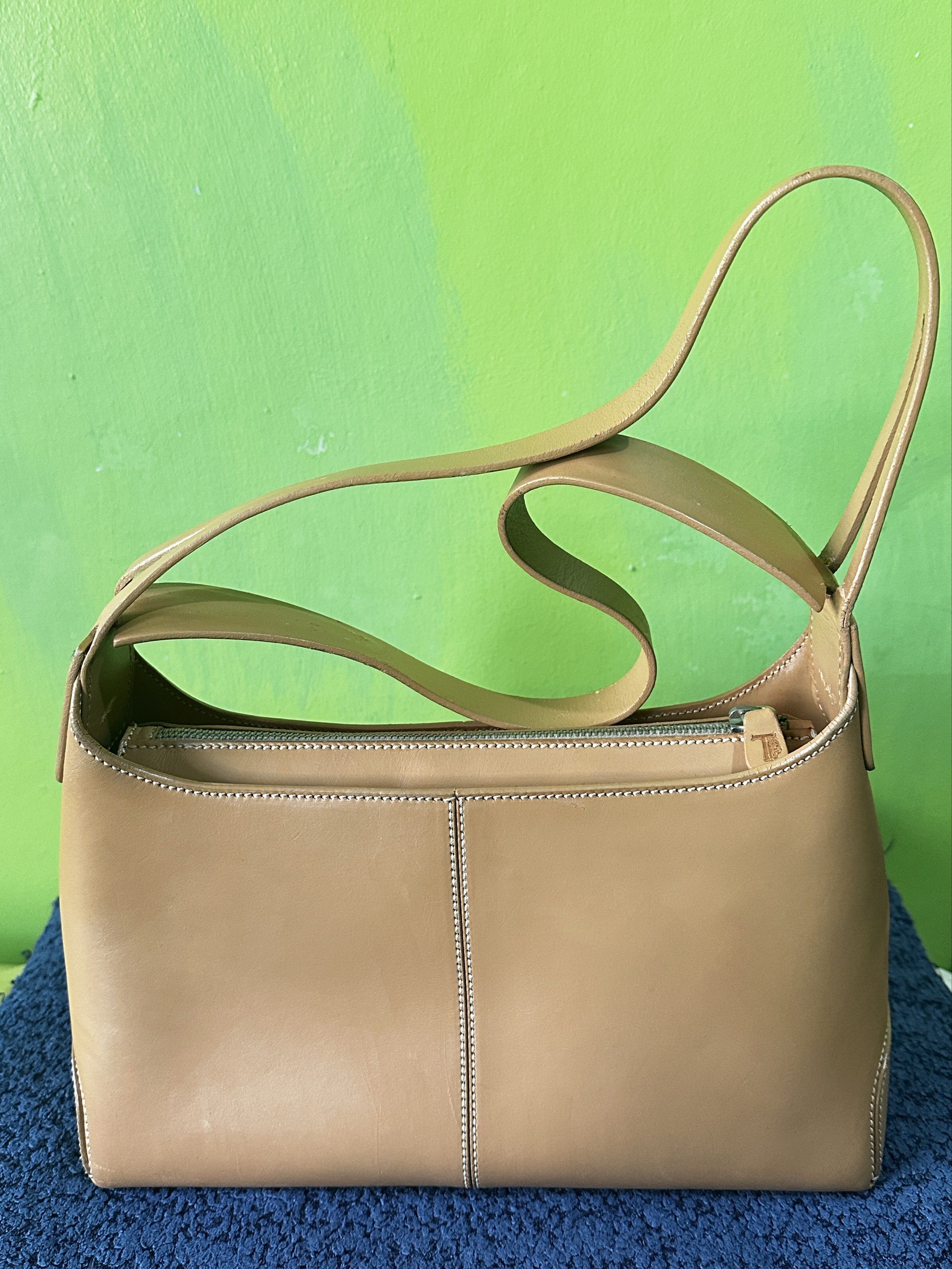 Tod's Camel Leather Classic Hobo Shoulder Bag (Category: Luxury Bags & Wallets) located in Angeles City. Submitted by n_cln (Listing ID 1419193702, Image 3). Description: - guaranteed Authentic Tod's classic shoulder bag in Camel - genuine leather made in Italy - working top zipper closure w/ shoulder strap - w/ stitched detailing and metal feet - bought in a lux vintage shop in Tokyo - was repainted (per shop) & has minimal scratches which are b