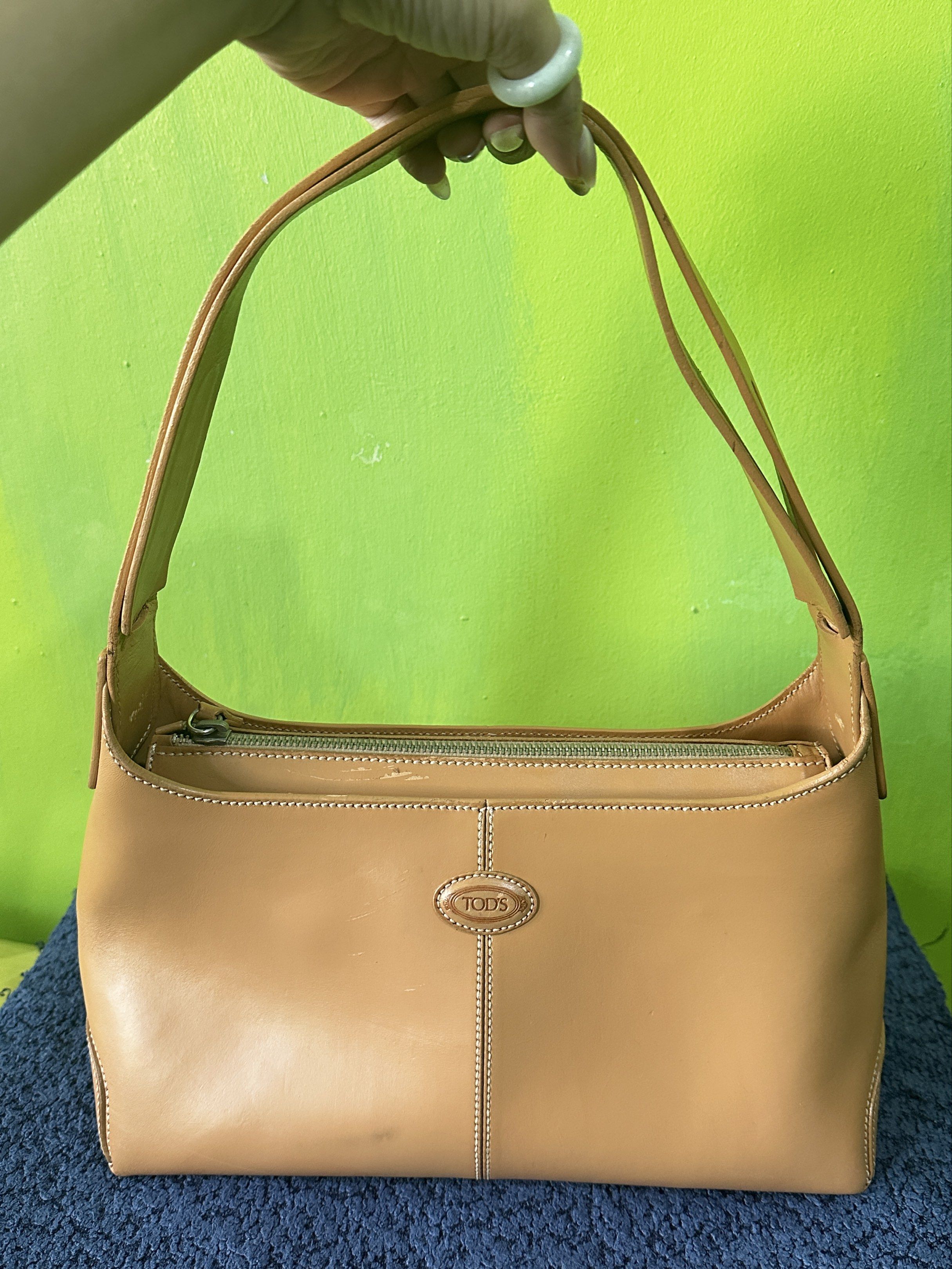 Tod's Camel Leather Classic Hobo Shoulder Bag (Category: Luxury Bags & Wallets) located in Angeles City. Submitted by n_cln (Listing ID 1419193702, Image 2). Description: - guaranteed Authentic Tod's classic shoulder bag in Camel - genuine leather made in Italy - working top zipper closure w/ shoulder strap - w/ stitched detailing and metal feet - bought in a lux vintage shop in Tokyo - was repainted (per shop) & has minimal scratches which are b