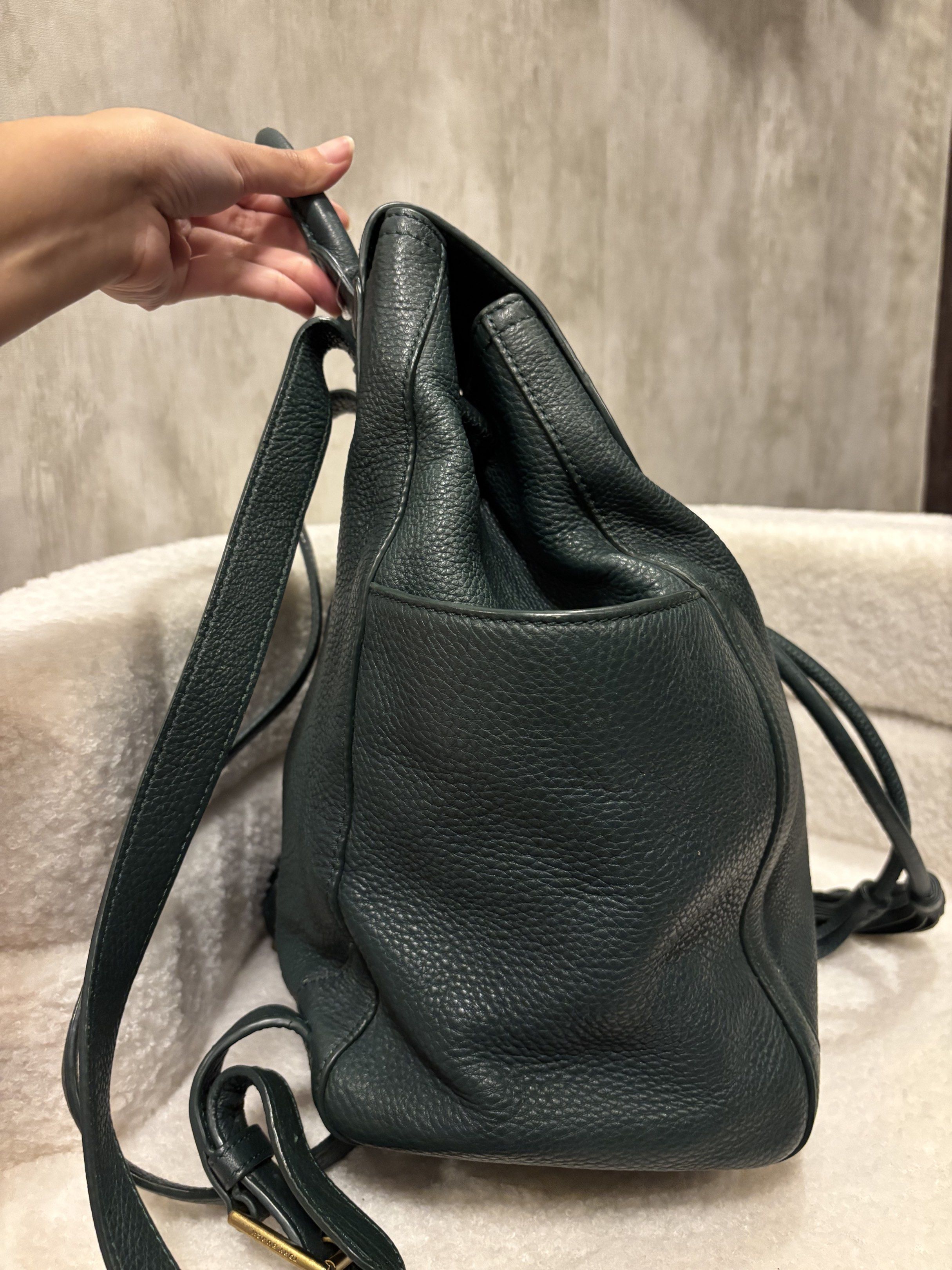 Tory Burch Leather Backpack (Category: Luxury Bags & Wallets) located in Manila. Submitted by _thepursela (Listing ID 1419313449, Image 3). Description: Stylish Tory Burch backpack in a deep teal color. Features a drawstring closure, top handle, and side pockets. The interior is lined with the Tory Burch logo pattern. The backpack has adjustable straps and a gold-tone logo emblem on the front..