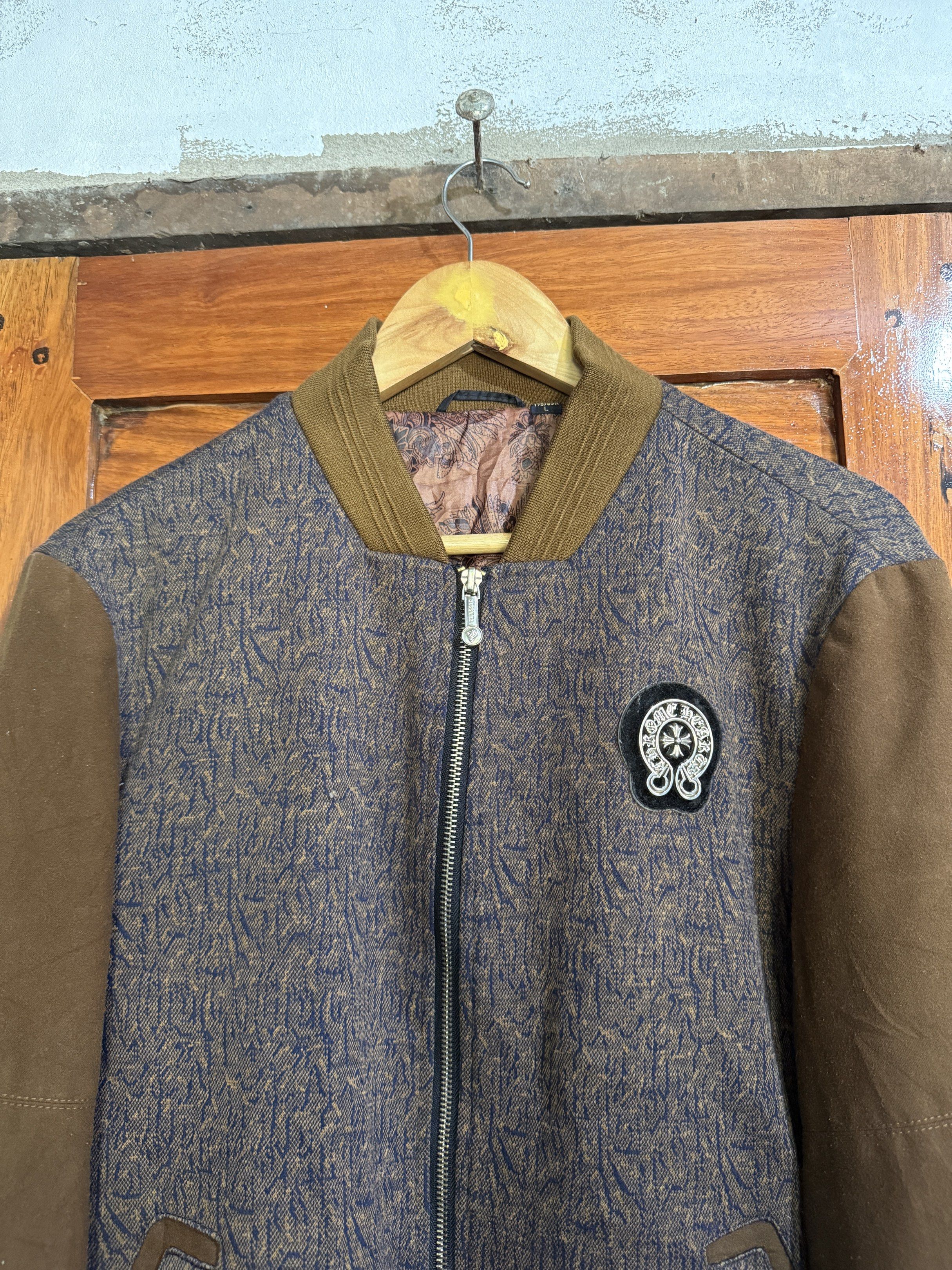 Varsity Jacket with Patch (Category: Coats, Jackets and Outerwear) located in Manila. Submitted by keepercollection (Listing ID 1419204902, Image 2). Description: - Stylish varsity jacket - Unique patterned body - Contrasting brown sleeves - Front zipper closure - Chest patch detail - Brown collar and cuffs - Patterned design on the back - Versatile wardrobe piece.