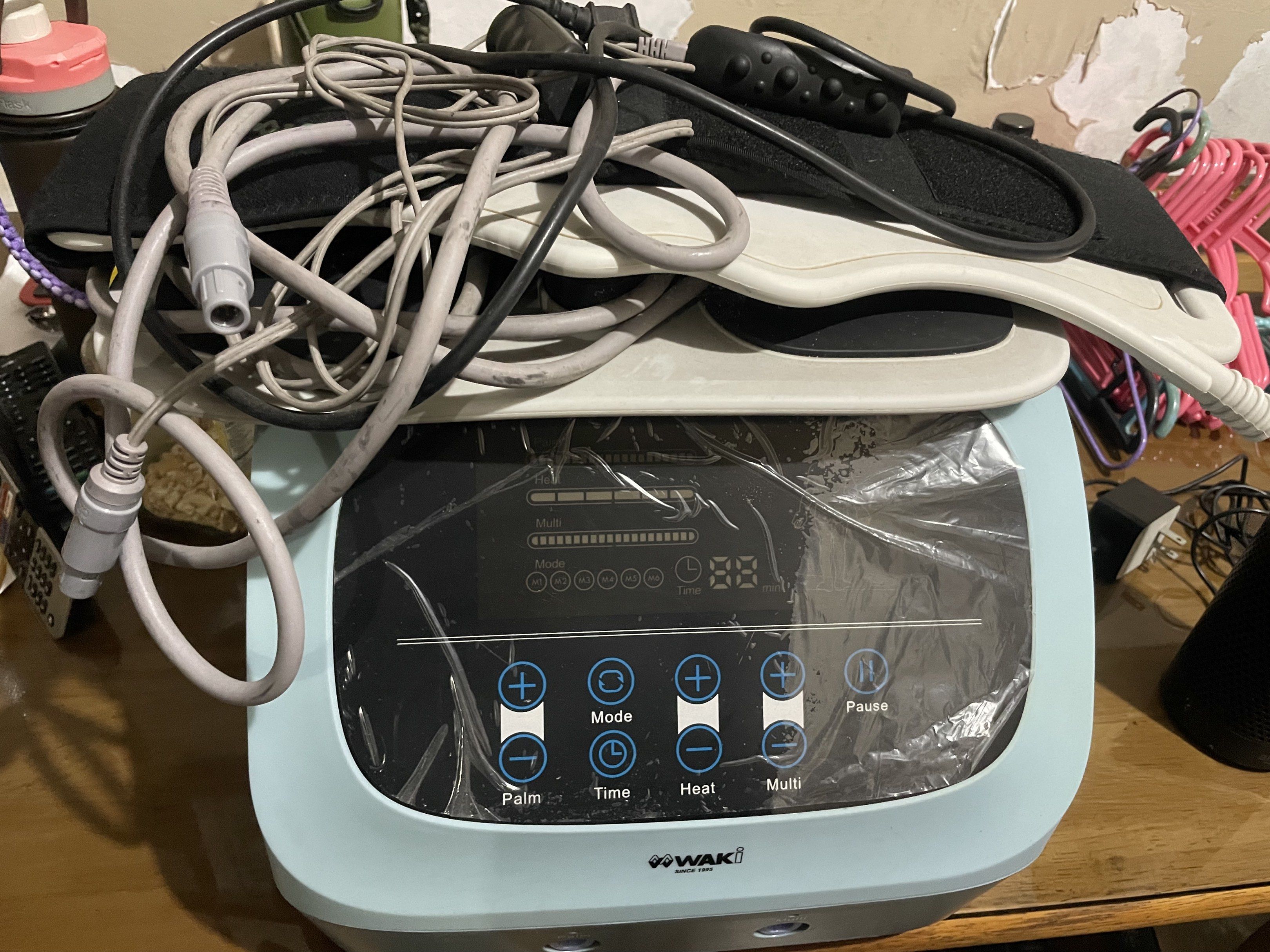 WAKI Body Massager (Category: Massage Devices) located in Manila. Submitted by cosmiccloud-adf7 (Listing ID 1419256485, Image 3). Description: - WAKI body massager - Multiple settings: Palm, Mode, Time, Heat, Multi - Includes various attachments and cables - Digital display and control buttons - Color: Light blue and gray.