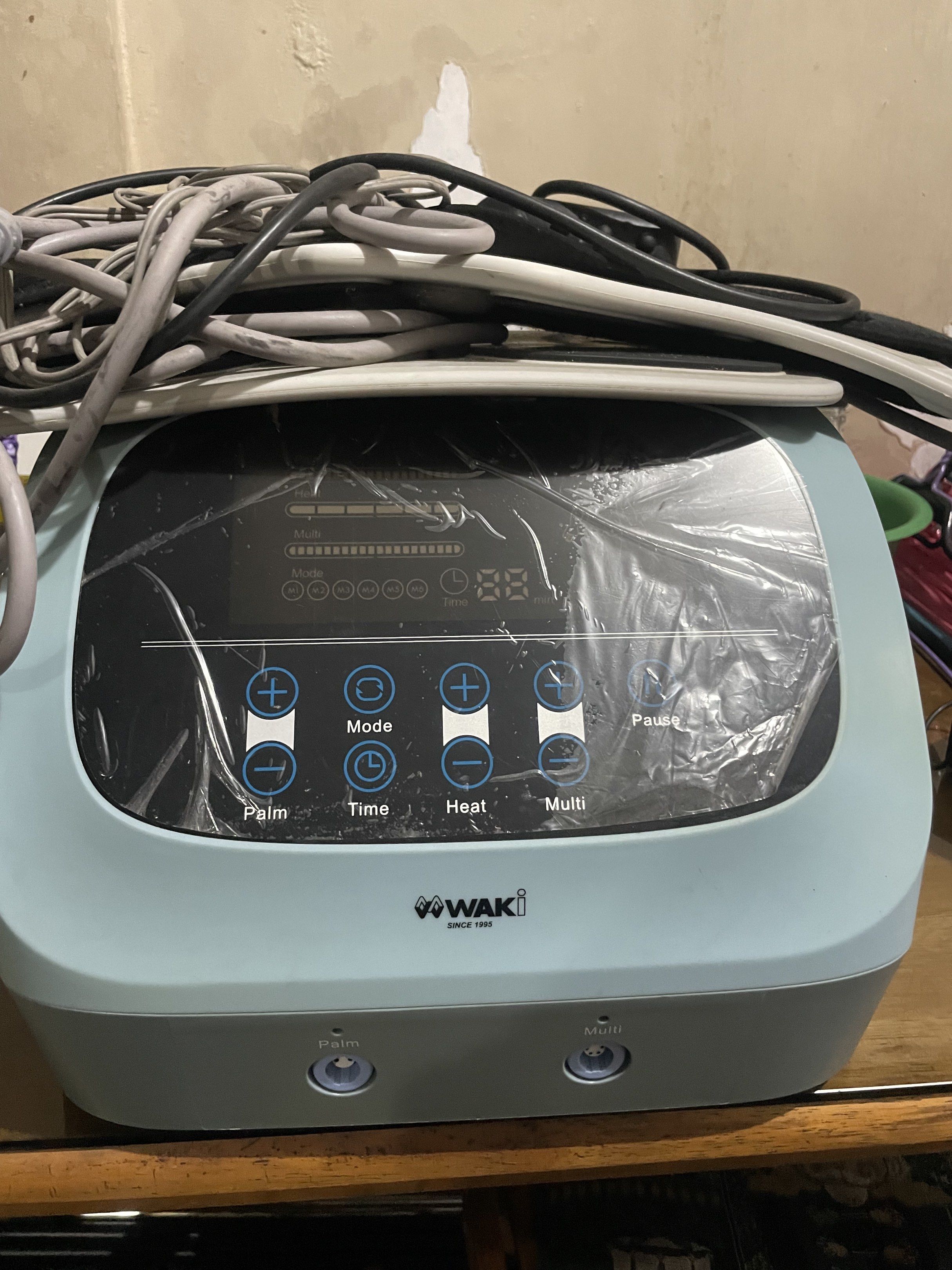 WAKI Body Massager (Category: Massage Devices) located in Manila. Submitted by cosmiccloud-adf7 (Listing ID 1419256485, Image 1). Description: - WAKI body massager - Multiple settings: Palm, Mode, Time, Heat, Multi - Includes various attachments and cables - Digital display and control buttons - Color: Light blue and gray.