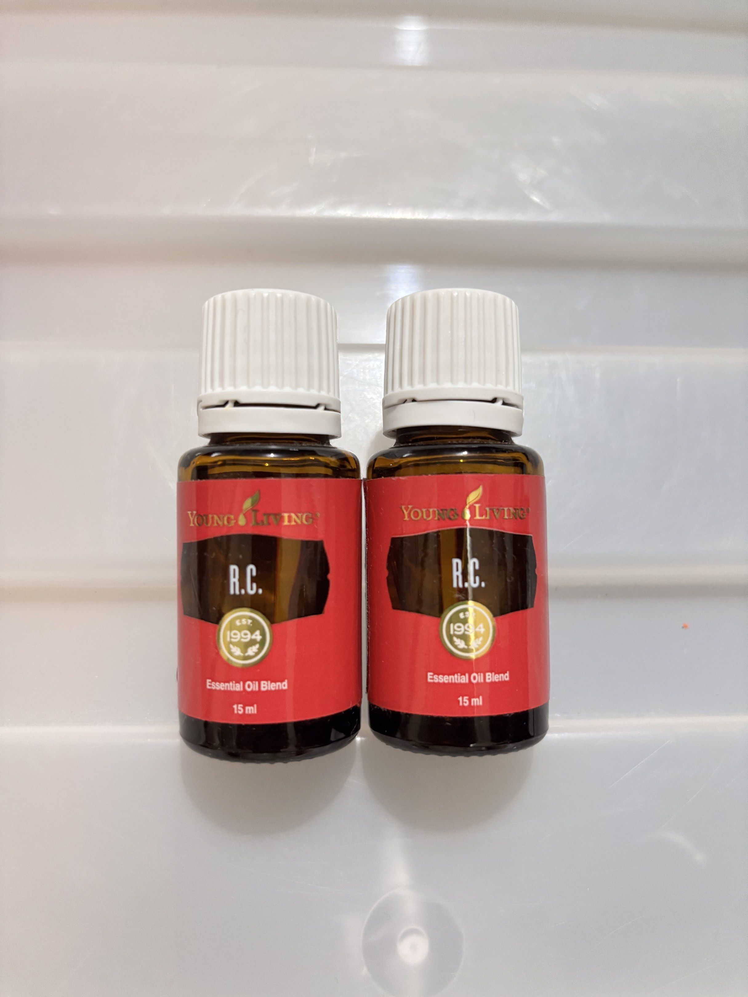 Young Living R.C. Essential Oil Blend 15ml (Category: Home Fragrance) located in Concepcion. Submitted by cherishedthreads (Listing ID 1419258846, Image 1). Description: - Two bottles of Young Living R.C. Essential Oil Blend - Each bottle contains 15ml - Authentic blend from 1994 - Features a red label.