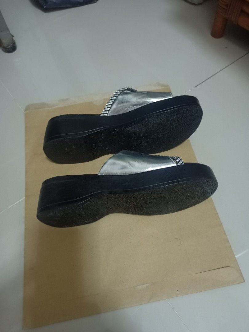 Zoo Ta You Ta Silver Sandals (Category: Sandals) located in Rizal. Submitted by HistoricalCoin (Listing ID 1419267509, Image 2). Description: Stylish silver sandals with a black sole. Features the brand name "Zoo Ta You Ta" on the insole. The sandals have a platform sole and a strap design. Perfect for casual wear. Comfortable and easy to slip on..