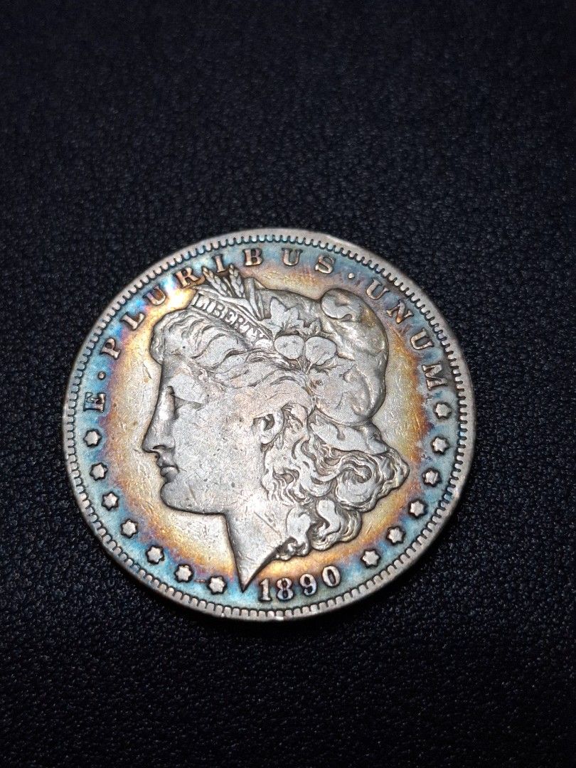 1890 Morgan Silver Dollar Coin CC Carson City (Category: Currency) located in Quezon City. Submitted by ejo23 (Listing ID 1422404565, Image 1). Description: 1890 CC (Carson City) Morgan Silver Dollar. Condition is notably fine. Ungraded, but appears to be around VF/Very Fine. Has the rare Carson City CC mint mark. Non magnetic, 90% silver. 26.5 grams when put on a weighing scale so it's within the common tolerance for lightly circulated coins. Ha