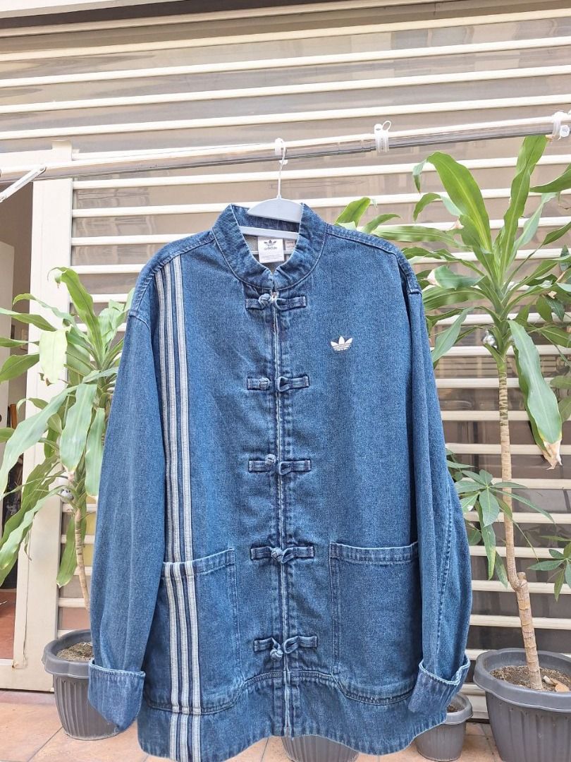 ADIDAS CNY DENIM JACKET (Category: Tshirts & Polo Shirts ) located in Manila. Submitted by luxuryfindersph (Listing ID 1422422331, Image 1). Description: BRAND NEW!!! ADIDAS CNY DENIM JACKET A limited-edition jacket for the Chinese New Year, crafted with premium denim and an oriental silhouette. This piece features traditional frog button closures (pankou), a mandarin collar, and classic adidas Three-Stripes branding, for a festive and stylish fe