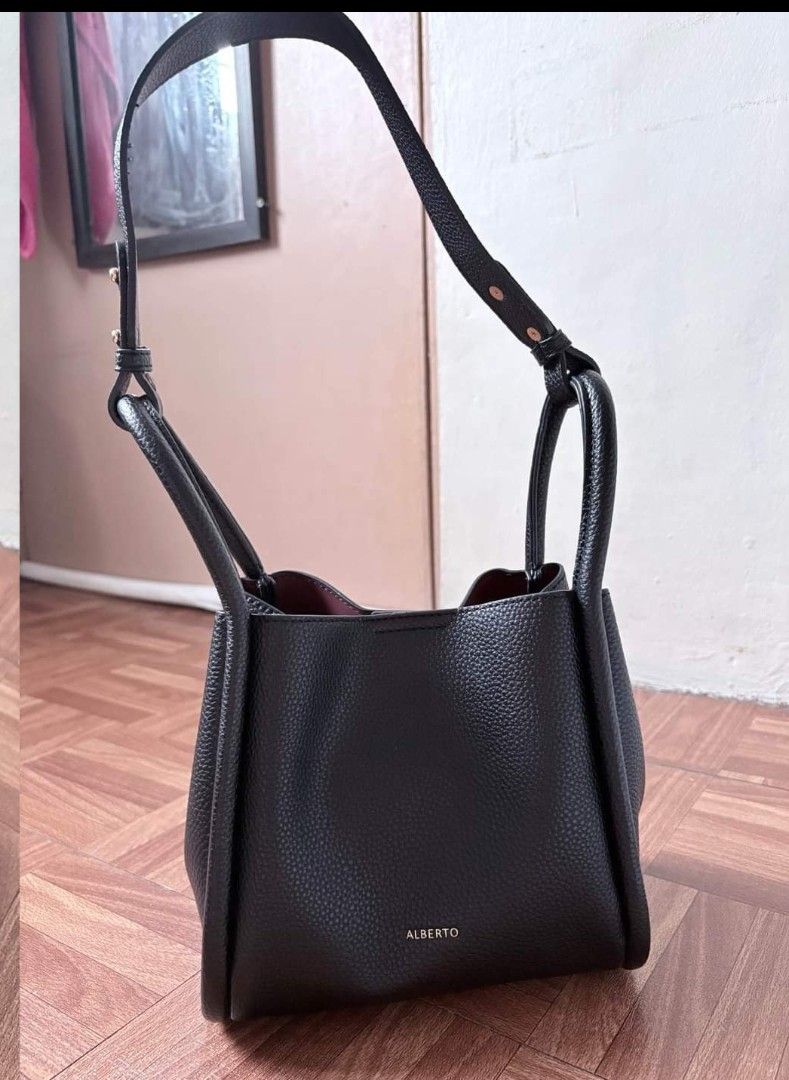 Alberto Black Shoulder Bag 🖤 (Category: Luxury Bags & Wallets) located in Pasay City. Submitted by mjdiaz.43 (Listing ID 1422409369, Image 2). Description: Black shoulder bag with a top handle and a longer strap. The bag has a structured shape and a subtle logo on the front. The bag has a simple, elegant design suitable for everyday use..