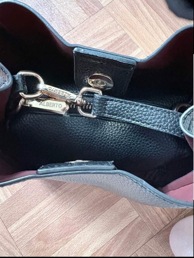 Alberto Black Shoulder Bag 🖤 (Category: Luxury Bags & Wallets) located in Pasay City. Submitted by mjdiaz.43 (Listing ID 1422409369, Image 3). Description: Black shoulder bag with a top handle and a longer strap. The bag has a structured shape and a subtle logo on the front. The bag has a simple, elegant design suitable for everyday use..