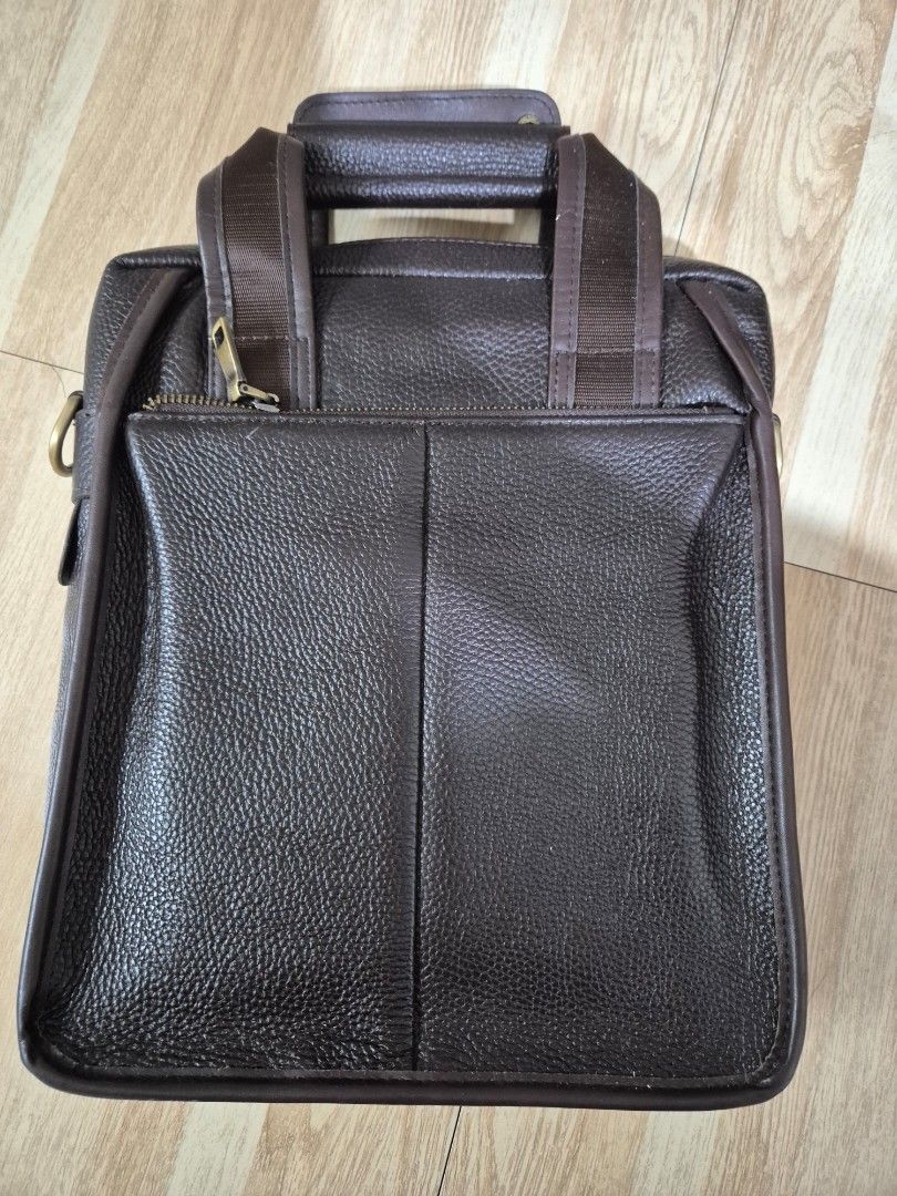 Brown Leather Laptop Bag (Category: Laptop Bags & Sleeves) located in Manila. Submitted by bajoyskie (Listing ID 1422434611, Image 3). Description: - Brown textured leather laptop bag - Top handle and detachable shoulder strap - Zippered main compartment - Interior pocket - Gold-toned hardware - Suitable for laptops and essentials.