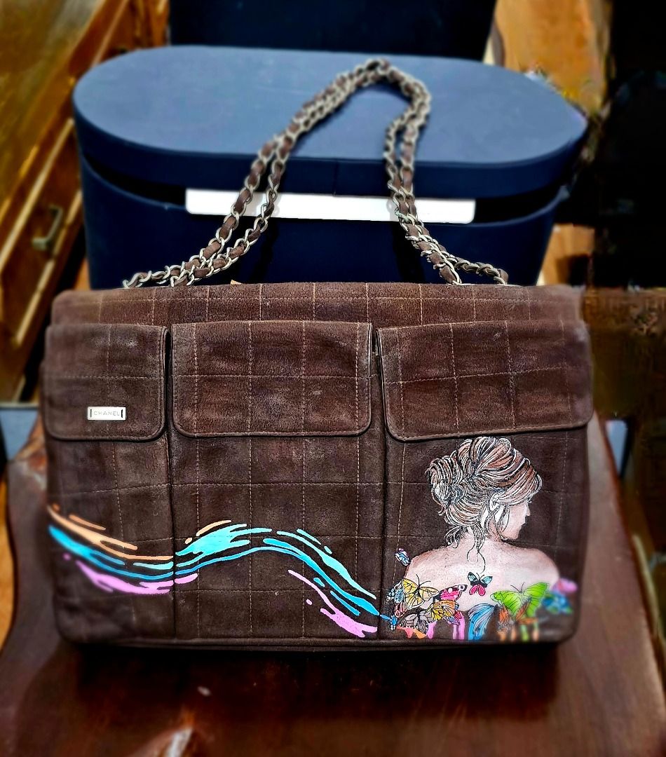 Chanel 2.55 Suede Handbag (authentic) (Category: Luxury Bags & Wallets) located in Caloocan City. Submitted by mhelcgm (Listing ID 1422427690, Image 3). Description: - Authentic Chanel 2.55 handbag - Brown suede material - Classic flap closure - Chain strap - Features custom artwork - Includes Chanel label and serial number - Made in France.