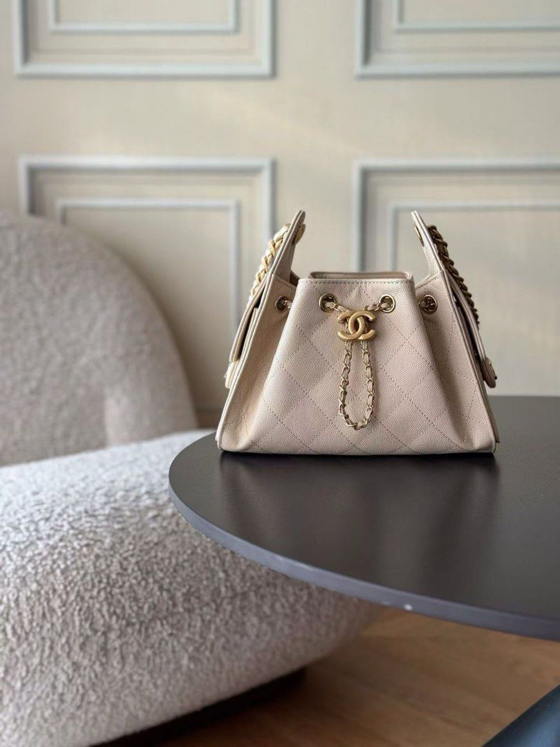 Chanel Drawstring Handbag with Chain (Category: Luxury Bags & Wallets) located in Manila. Submitted by mscate (Listing ID 1422445796, Image 1). Description: - Chanel handbag - Drawstring closure - Iconic chain detailing - Quilted design - Features the Chanel logo - Available in multiple colors: beige, burgundy, rose gold, dark brown, pink, white, coral, tan, and purple..
