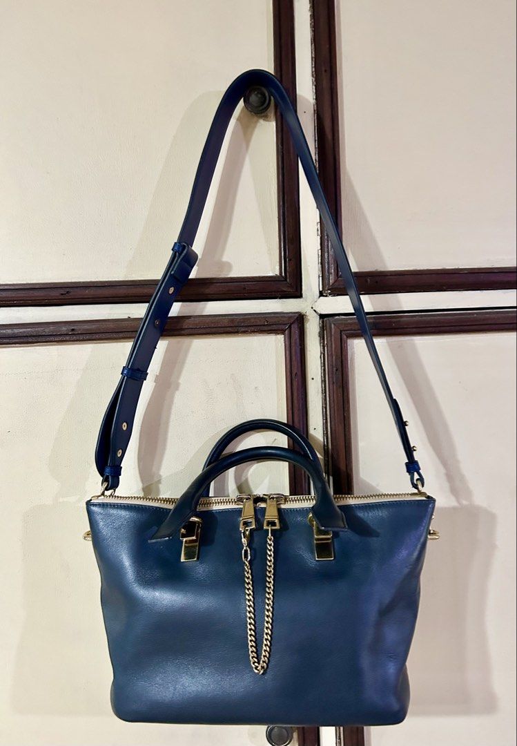 Chloe Baylee Handbag (Category: Luxury Bags & Wallets) located in Manila. Submitted by rosamanerds (Listing ID 1422413875, Image 1). Description: - Authentic preloved Chloe Baylee leather handbag in excellent condition. With minor signs of use (pls see 3rd pic) - Dual-tone design . Color is navy blue and taupe - Top handle and detachable shoulder strap - Gold-tone zipper and hardware - Interior with Chloe label and small pocket with holo sticker 