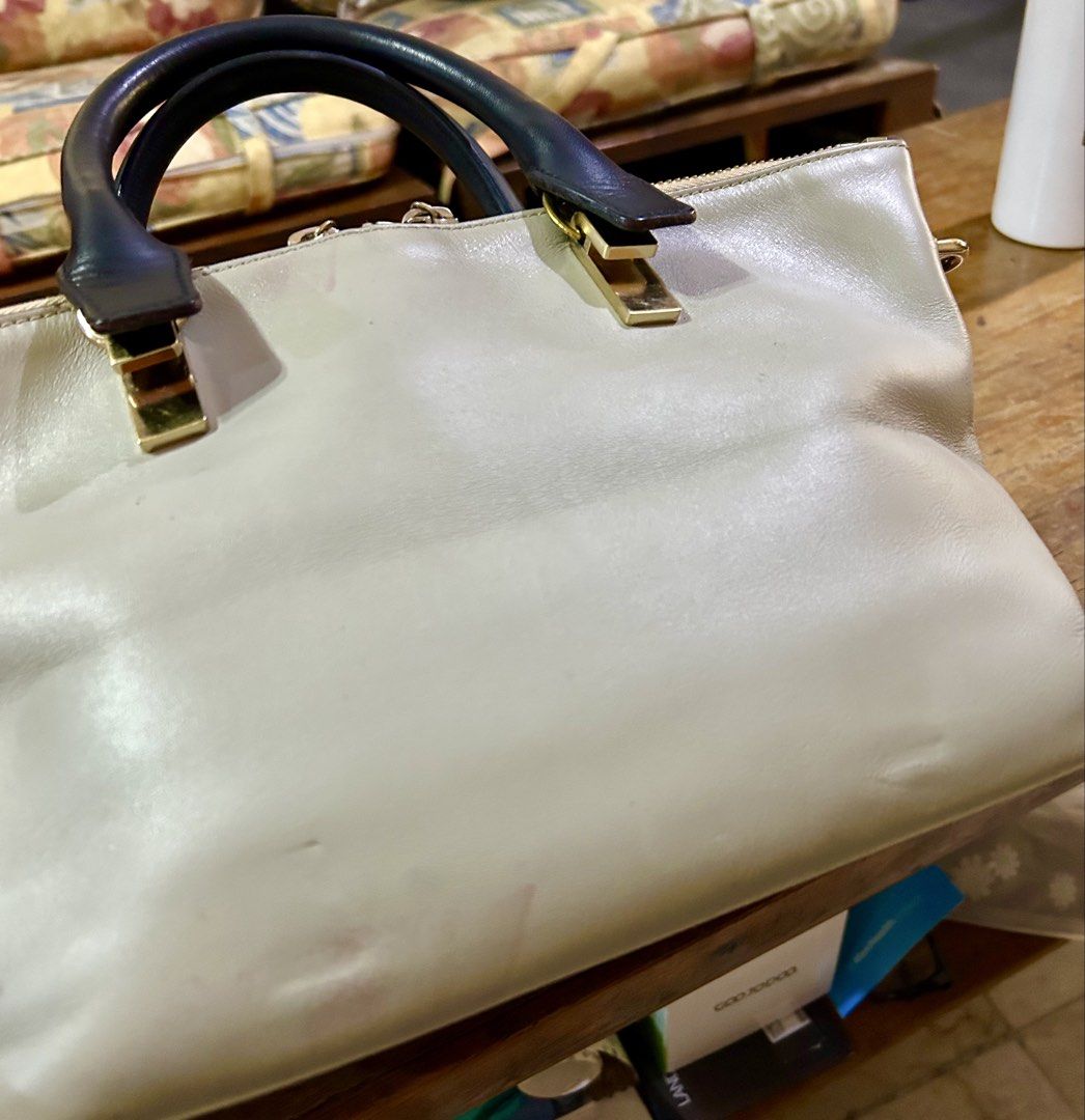 Chloe Baylee Handbag (Category: Luxury Bags & Wallets) located in Manila. Submitted by rosamanerds (Listing ID 1422413875, Image 3). Description: - Authentic preloved Chloe Baylee leather handbag in excellent condition. With minor signs of use (pls see 3rd pic) - Dual-tone design . Color is navy blue and taupe - Top handle and detachable shoulder strap - Gold-tone zipper and hardware - Interior with Chloe label and small pocket with holo sticker 