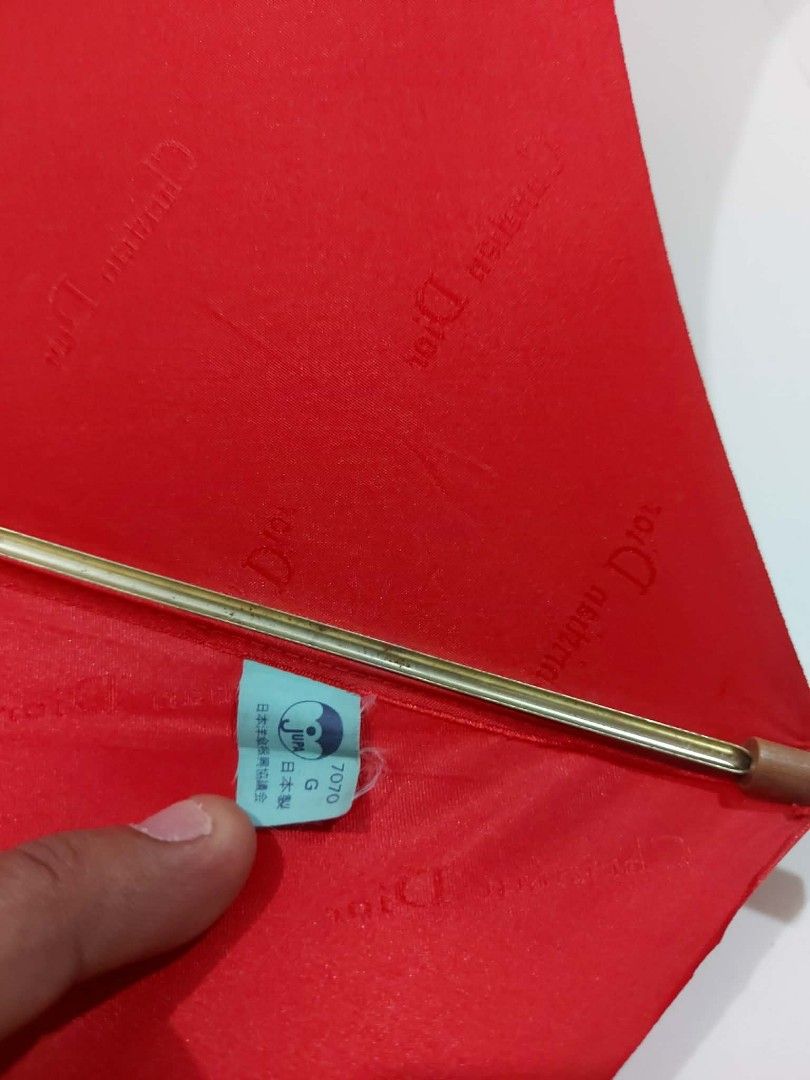 Christian Dior Red Umbrella (Category: Umbrellas) located in Bayombong. Submitted by Gentlemans_ClosEt (Listing ID 1422484534, Image 2). Description: - Authentic Christian Dior red umbrella - Subtle Dior logo inside - Wooden handle with Dior ring - Includes carrying strap - Vibrant red color - Perfect for rainy days.