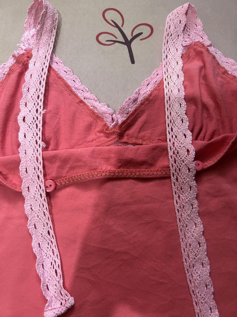 Pink Tank Top with Lace Trim (Category: Sleeveless) located in Quezon City. Submitted by rhaez (Listing ID 1422478973, Image 3). Description: SUPER STEAL! The strap can be normal, crossed, or halter! - Coral pink tank top - Delicate pink lace trim - V-neckline - Criss-cross back design - Lace detailing on straps and neckline - Two buttons at the back - Perfect for various occasions.