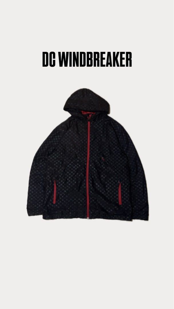 DC Windbreaker Jacket (Category: Coats, Jackets and Outerwear) located in Kuala Lumpur. Submitted by feeqstore.my (Listing ID 1422498621, Image 1). Description: - Black DC windbreaker jacket - Red accents and checkered pattern - Features a hood and full-length zipper - Two front pockets with red zippers - Measurements: P22.5, L28.5 - Price: RM35.