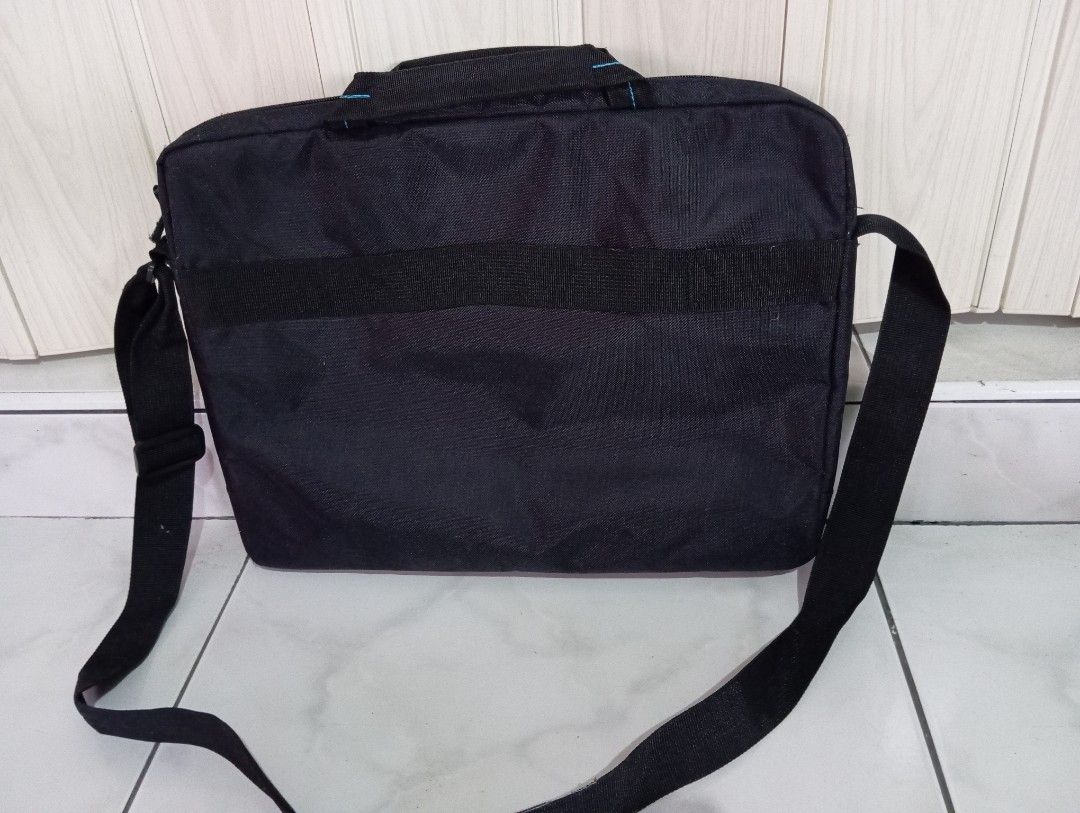 Dell Laptop Bag with Shoulder Strap (Category: Laptop Bags & Sleeves) located in Dasmarinas. Submitted by kei05 (Listing ID 1422406489, Image 2). Description: Black Dell laptop bag with a shoulder strap and a top handle. It has a front pocket with a zipper and a blue accent. The Dell logo is visible on the front. It has a simple design, suitable for everyday use..