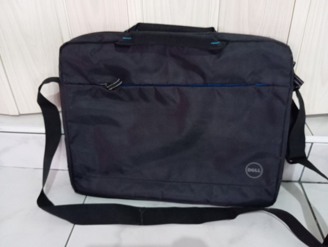 Dell Laptop Bag with Shoulder Strap (Category: Laptop Bags & Sleeves) located in Dasmarinas. Submitted by kei05 (Listing ID 1422406489, Image 1). Description: Black Dell laptop bag with a shoulder strap and a top handle. It has a front pocket with a zipper and a blue accent. The Dell logo is visible on the front. It has a simple design, suitable for everyday use..