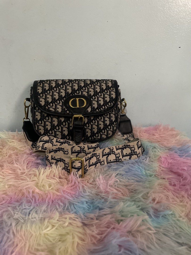 Dior Saddle Bag with Strap (Category: Luxury Bags & Wallets) located in Pasig City. Submitted by ladyboss1012 (Listing ID 1422484783, Image 1). Description: - Dior Saddle Bag - Iconic Dior Oblique pattern - Detachable strap for shoulder or crossbody wear - Flap closure with gold-tone CD buckle - Single interior compartment.