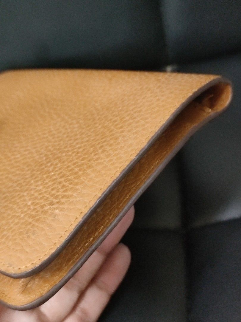 Hermes Leather Wallet (Category: Luxury Bags & Wallets) located in Basud. Submitted by ClaireLavin (Listing ID 1422471423, Image 3). Description: - Hermes wallet - Tan leather exterior - Removable card holder with orange stripe - Multiple compartments for cards and cash - Silver-tone hardware with Hermes logo.
