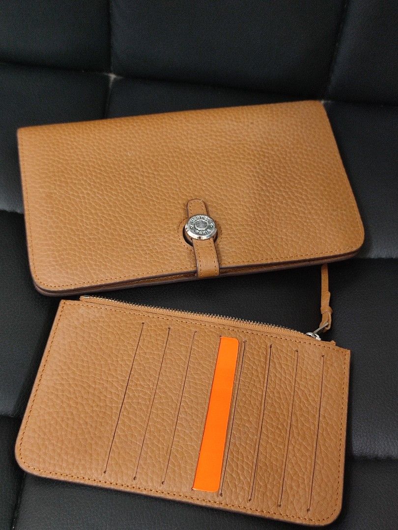 Hermes Leather Wallet (Category: Luxury Bags & Wallets) located in Basud. Submitted by ClaireLavin (Listing ID 1422471423, Image 1). Description: - Hermes wallet - Tan leather exterior - Removable card holder with orange stripe - Multiple compartments for cards and cash - Silver-tone hardware with Hermes logo.