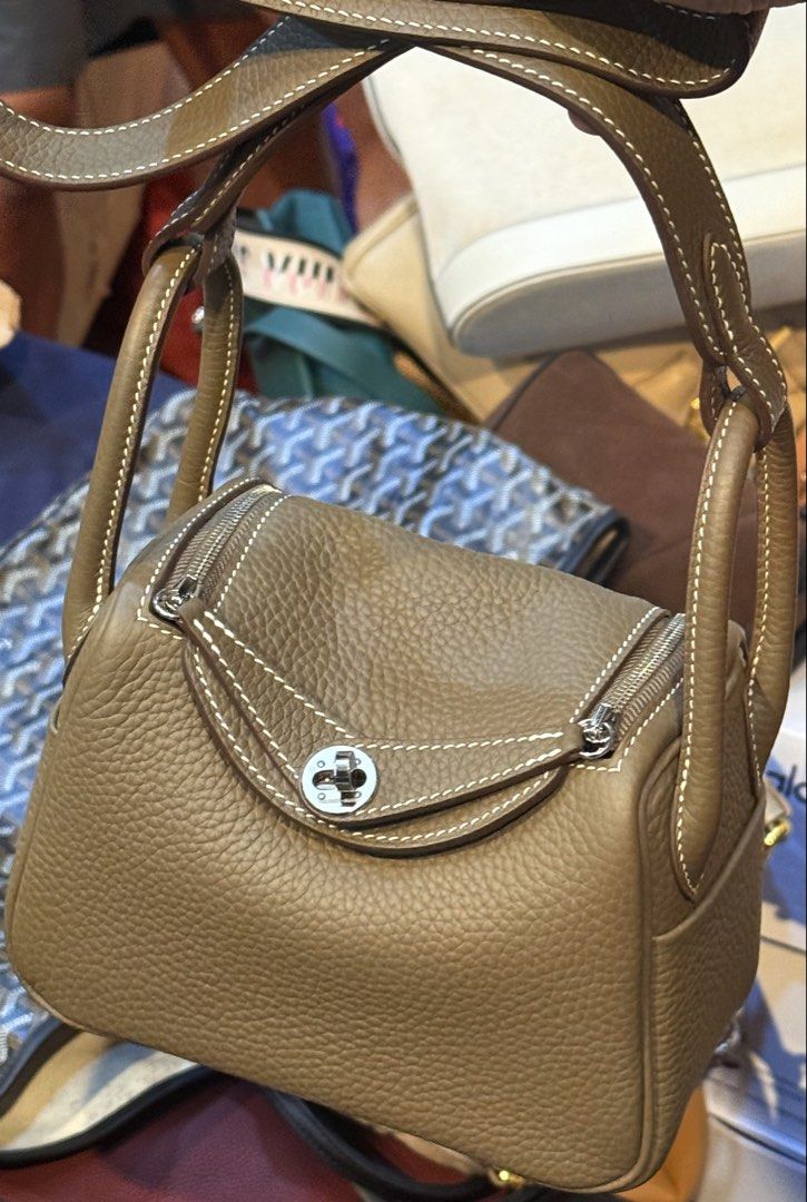 Hermès Lindy Bag (Category: Luxury Bags & Wallets) located in Manila. Submitted by thebodega88 (Listing ID 1422544250, Image 1). Description: - Hermès Lindy bag - Beautiful taupe color - Distinctive shape with dual zippers - Turn-lock closure - White stitching details - Pebbled leather texture - Matching interior lining - Made in France.