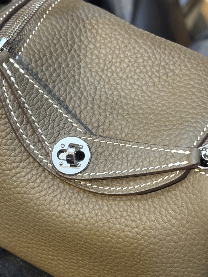Hermès Lindy Bag (Category: Luxury Bags & Wallets) located in Manila. Submitted by thebodega88 (Listing ID 1422544250, Image 2). Description: - Hermès Lindy bag - Beautiful taupe color - Distinctive shape with dual zippers - Turn-lock closure - White stitching details - Pebbled leather texture - Matching interior lining - Made in France.