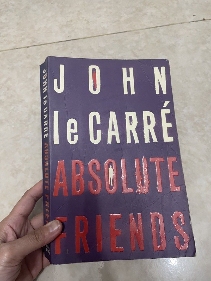 John le Carré Absolute Friends (Category: Storybooks) located in Paranaque City. Submitted by kashireadsbookstore (Listing ID 1422492409, Image 1). Description: - 'Absolute Friends' by John le Carré - English edition - Features a purple cover with white and red lettering - Includes a summary and quote on the back cover.