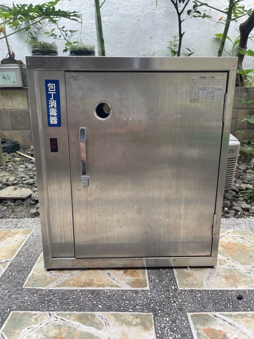 Kitchen knife Stainless Steel Sterilizer Cabinet (Category: Bathroom & Kitchen Fixtures) located in Manila. Submitted by chesterson1979. (Listing ID 1422436803, Image 1). Description: Kitchen knife Stainless steel sterilizer cabinet. Features a door with a handle and a power switch. Includes a rack inside for holding items. The cabinet has a hole on the front and a label with Japanese characters. Dimensions are approximately 23 inches in height, 