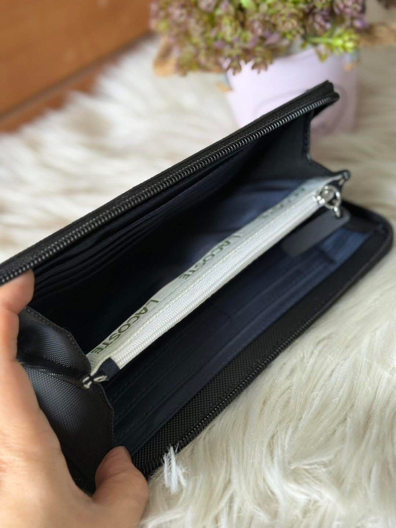 Lacoste Black Zip Around Wallet (Category: Wallets & Card holders) located in Manila. Submitted by clairetot (Listing ID 1422420037, Image 3). Description: Original Lacoste black zip-around wallet. Features the Lacoste logo, textured exterior, zip closure, multiple compartments, and a zippered pocket. Durable material..