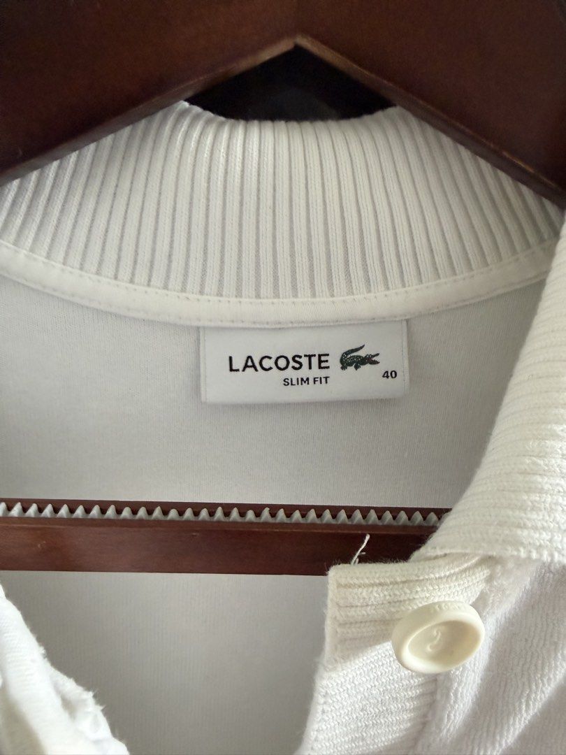 Lacoste Slim Fit Polo Shirt (Category: Blouses) located in Lipa City. Submitted by jenragragio (Listing ID 1422447253, Image 3). Description: - White Lacoste polo shirt - Size: 40 - Fit: Slim - Features a classic polo collar - Short sleeves - Iconic Lacoste logo on chest - Button-up placket - Fabric: Textured knit.
