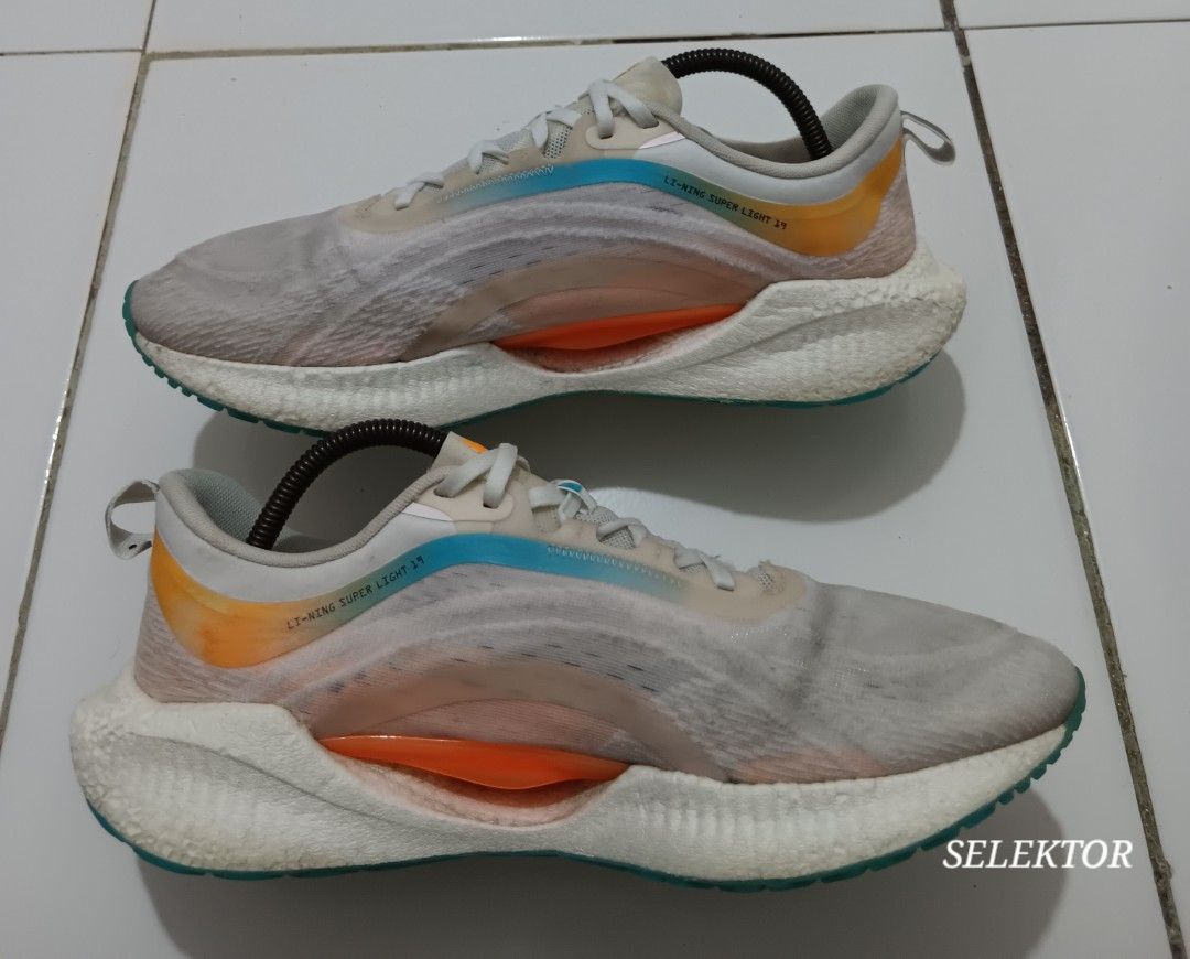 Li-Ning Super Light 19 Running Shoes - Size 9.5 (Category: Sneakers) located in Dauis. Submitted by udenglegaspi (Listing ID 1422459312, Image 2). Description: - Li-Ning Super Light 19 running shoes - Size: 9.5 US (27.5 CM) - Color: White, orange, and blue - Sole color: Teal - Features a mesh upper - Made in China.