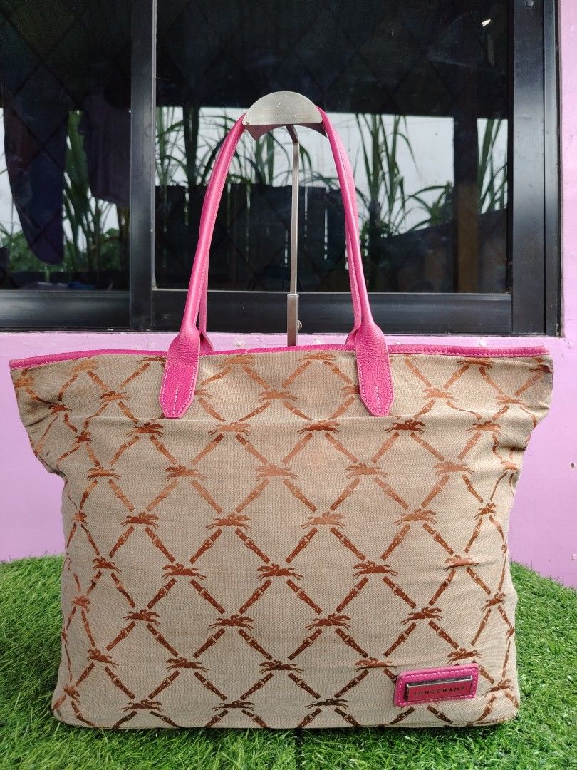 Long champ Le Pliage (Category: Luxury Bags & Wallets) located in Tagum. Submitted by mjprelovedbags2020 (Listing ID 1422394027, Image 2). Description: item is a beige and brown patterned Longchamp monogram shoulder tote bag with pink leather handles. L-18 inches W-11 inches Preloved japan surplus.