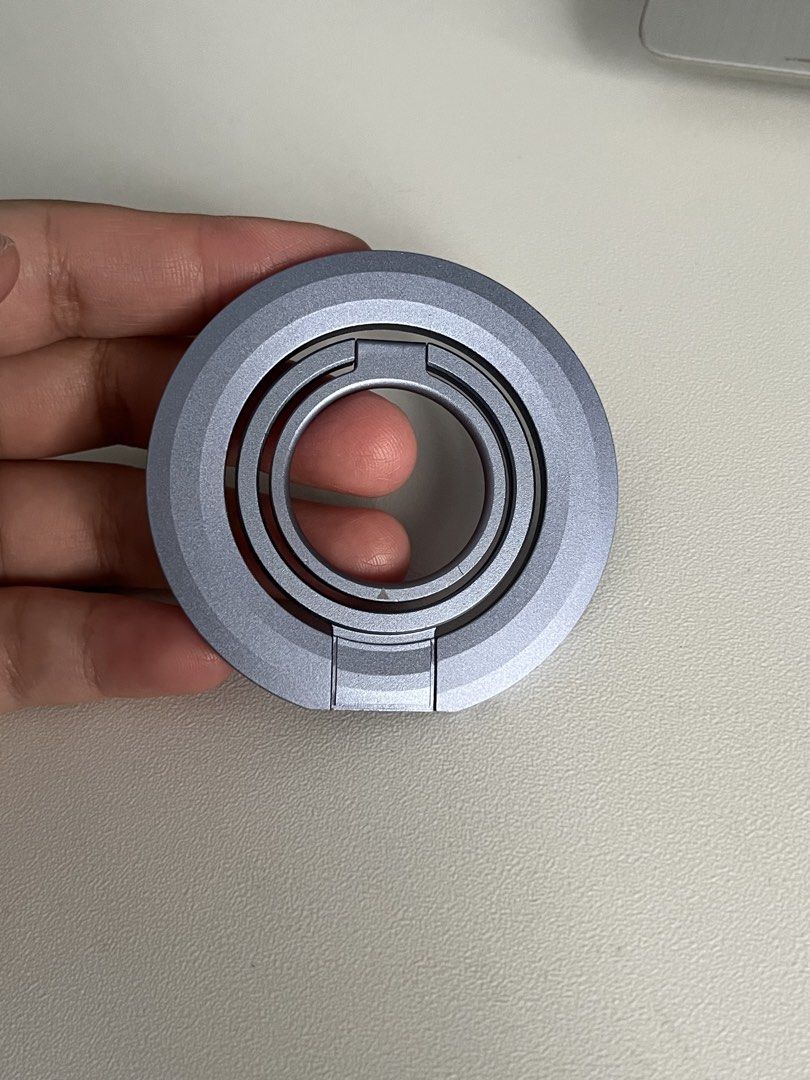 magnetic trifold ring phone stand kickstand (t. iphone android magsafe magnet popsocket) (Category: Other Gadgets) located in Las Pinas. Submitted by ofwingedmake (Listing ID 1422450225, Image 1). Description: - blue/purple/lavender color - trifold/adjustable/free rotation; can stand vertically or horizontally - strong, double-sided magnet (best if your phone case already has a magnet attached) - aluminum alloy frosted/matte finish before transac