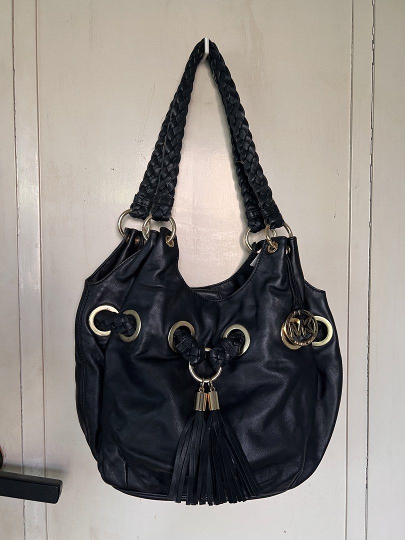 Michael Kors Black Leather Hobo Bag (Category: Luxury Bags & Wallets) located in Manila. Submitted by bby.yng (Listing ID 1422463292, Image 2). Description: - Michael Kors black leather hobo bag - Braided shoulder straps - Gold-tone hardware - Tassel detail - MK logo charm - Interior zip pocket - Monogram lining - Spacious interior - with free dust bag.
