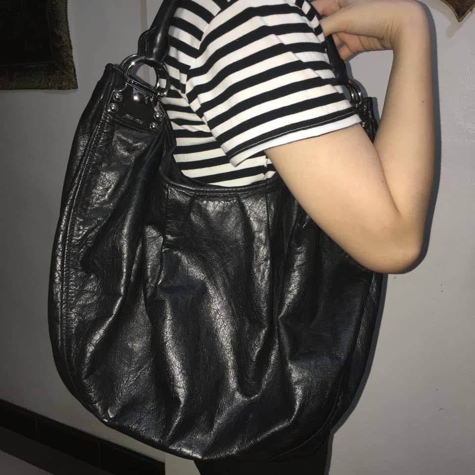 Miu Miu Black Hobo Bag (Category: Luxury Bags & Wallets) located in Manila. Submitted by mariantim76369 (Listing ID 1422409792, Image 3). Description: ⭕️Personal bag. NOT UKAY SOURCE⭕️ - Black Miu Miu hobo bag - Large, slouchy design - Single shoulder strap - Silver-tone hardware - Miu Miu logo on exterior and interior - Dark fabric lining.